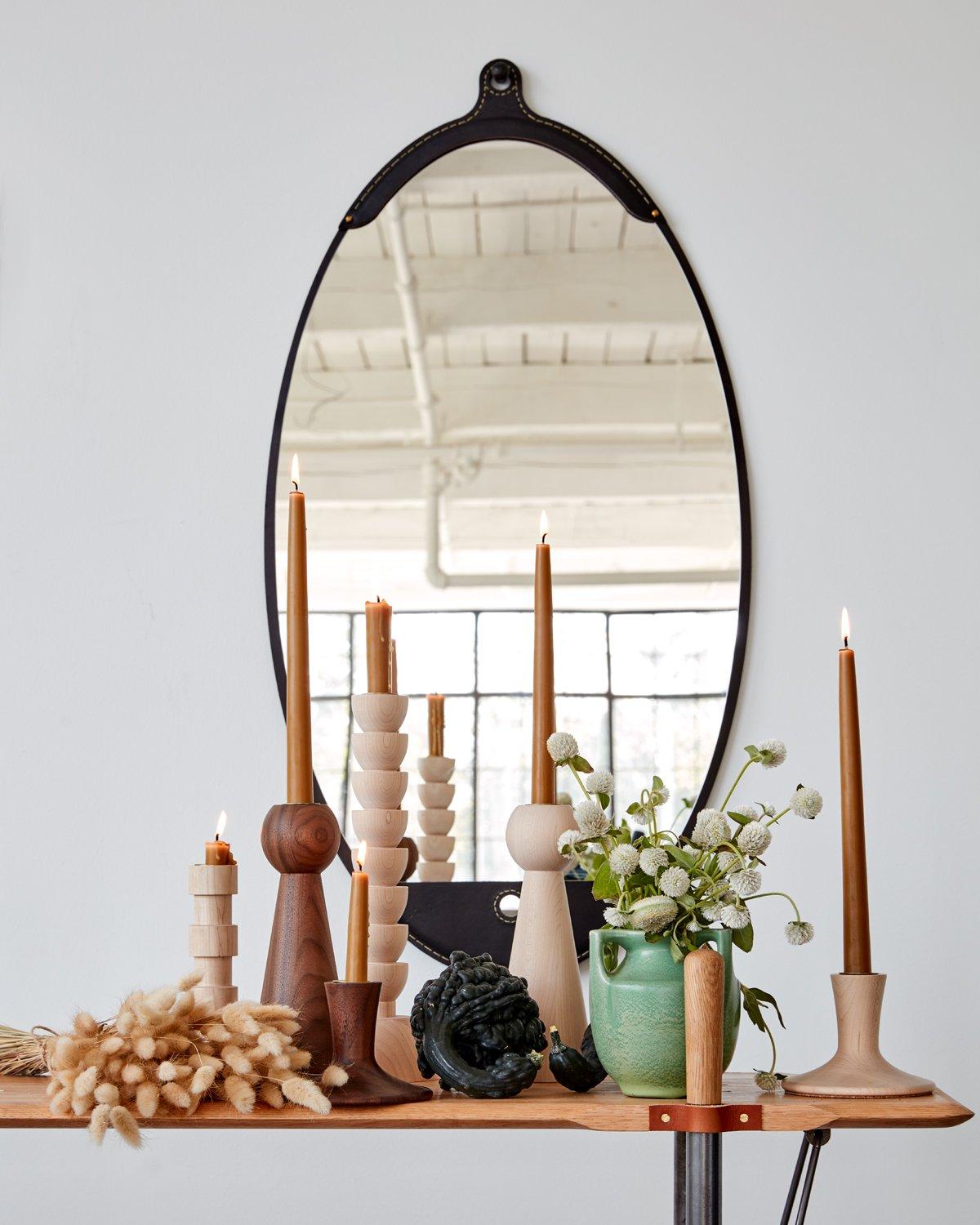 The Fairmount wide oval mirror is a hand-stitched leather mirror. Each piece of leather has its own character and variations lending to the appeal of the material. The mirror sits inside the frame like a pocket and comes with an iron hand hammered
