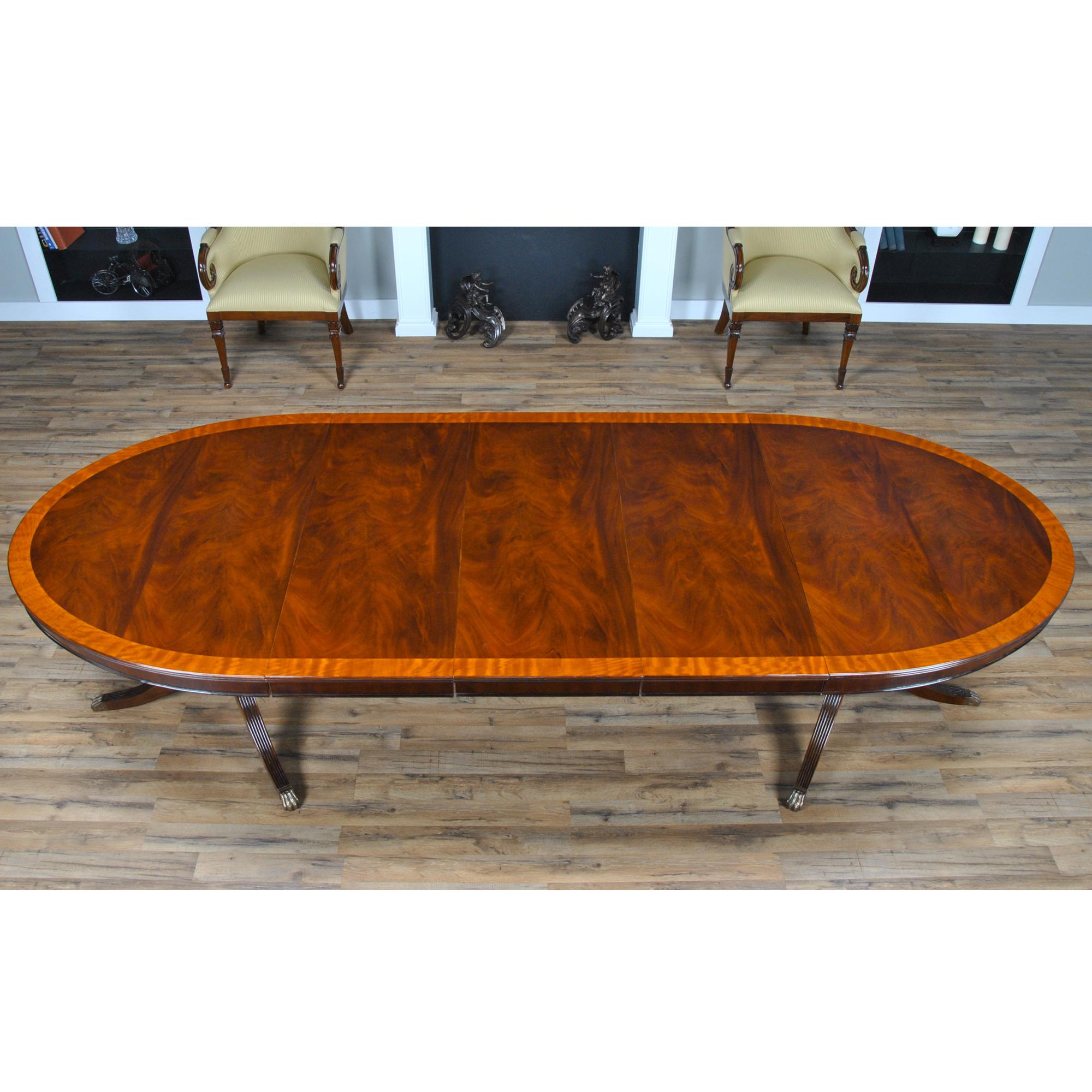 An unusual Long Oval Mahogany Dining Table.  A great table for narrower spaces this dining tables’ tapered ends allow for greater movement around the table even when guests are seated. When closed the long Oval Mahogany Dining Table closes to a
