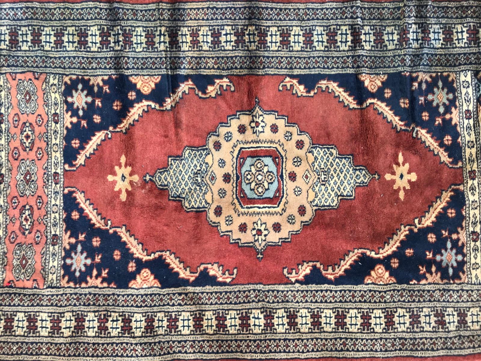 Late 20th century Pakistan corridor rug with a geometrical design and beautiful colors with blue, brown, pink and purple, entirely hand knotted with wool velvet on cotton foundation.