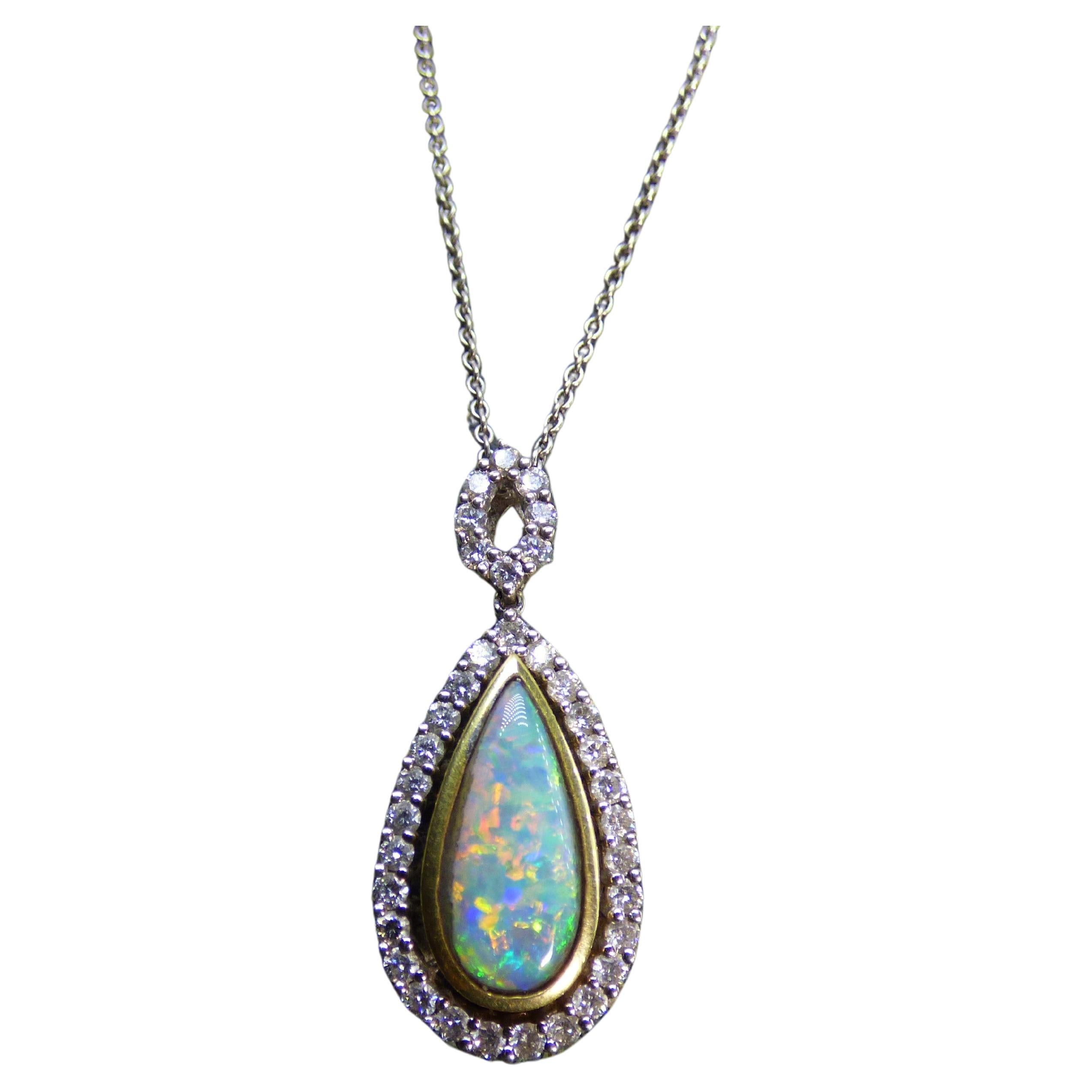 Long pear shaped Opal and Diamond Pendant with 18" chain in 18K gold. For Sale