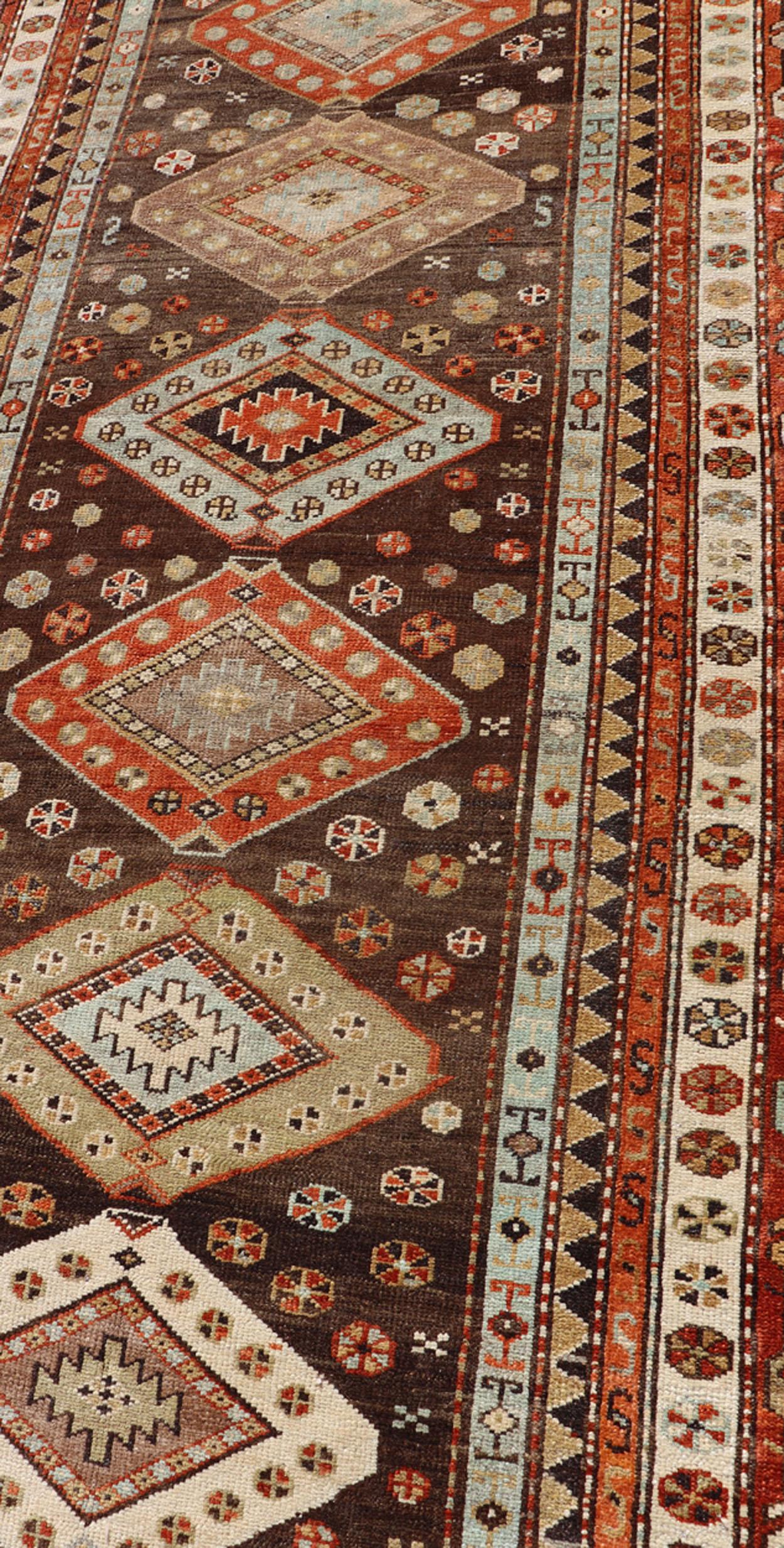 20th Century Long Persian Kurdish Runner with Medallion Design in Brown, Orange and Cream For Sale