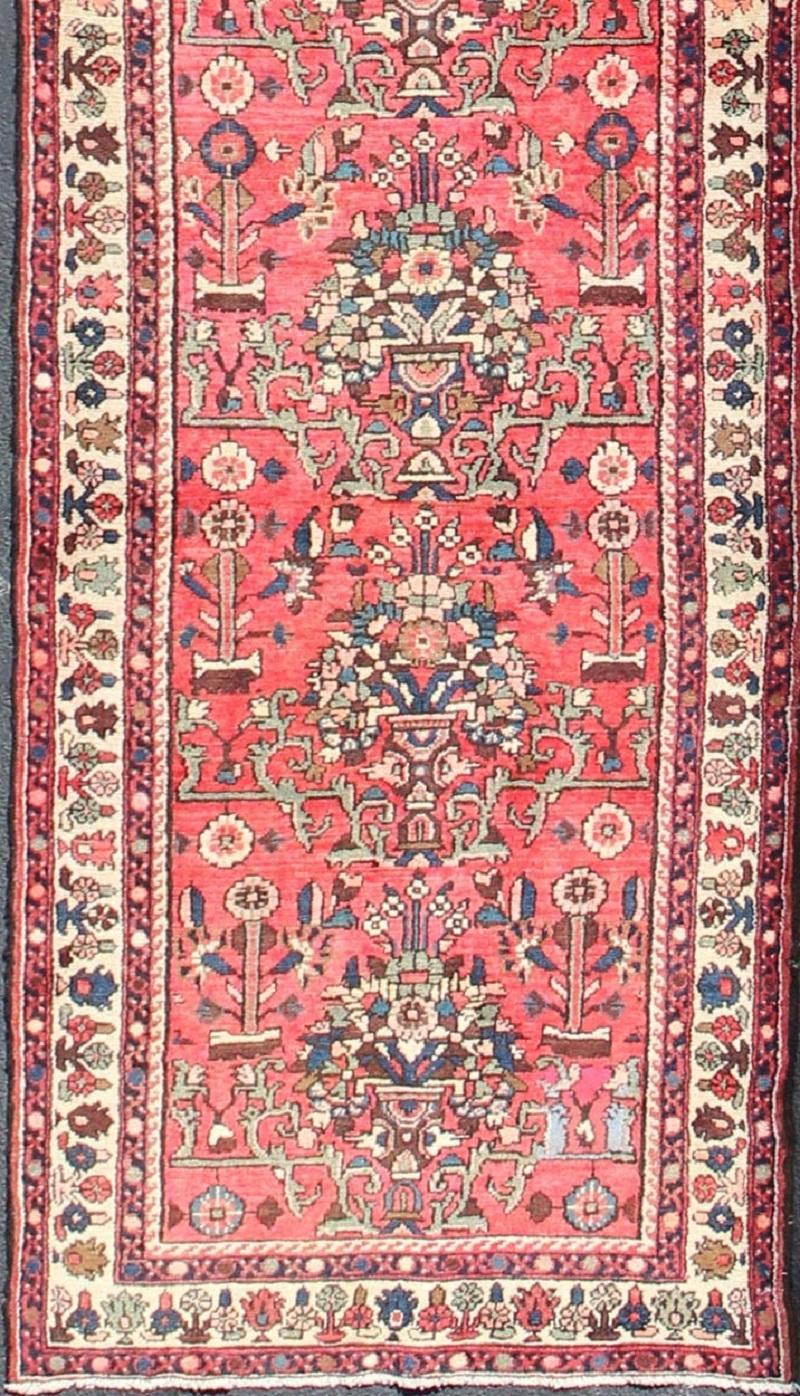 Long Hand-Knotted Persian Runner, rug H-602-37, country of origin / type: Persian / Malayer, circa mid-20th century

This Persian Hamadan long runner from mid-20th century Iran features an all-over pattern set on a crimson background, which is