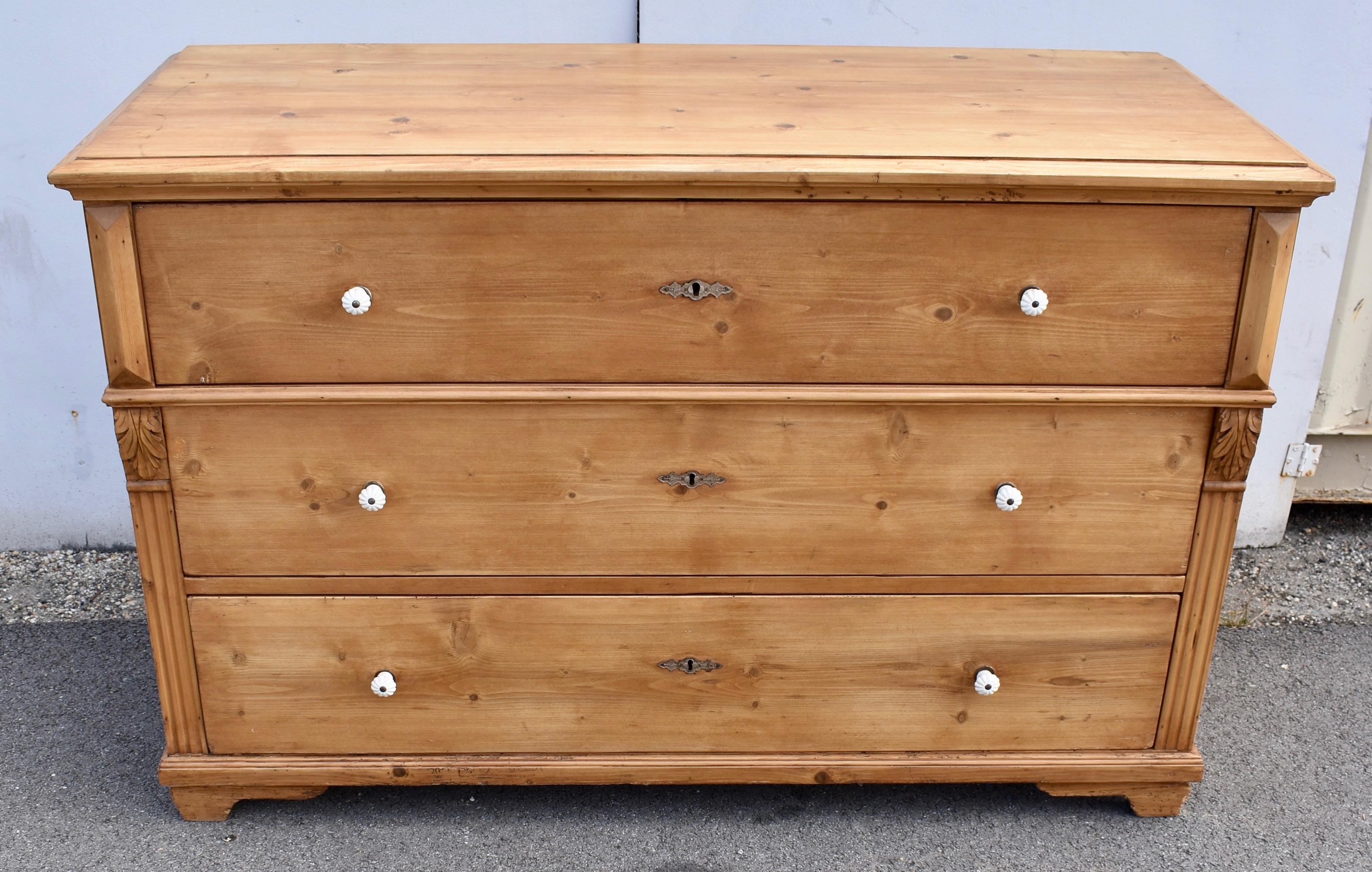 At almost five feet long this magnificent piece is unusually large for a single row chest of drawers.  A bold ogee molding to the front and sides of the top creates a step-down edge.  The three drawers are more or less equal in depth with the top