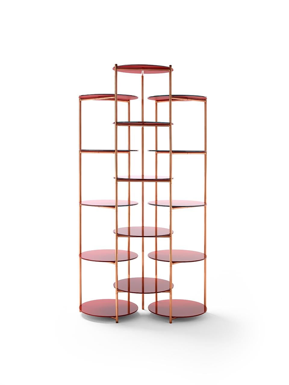 An essential but rich étagère featuring 3 columns made of copper tubing, each one supporting 4 circular shelves made of back-painted glass. Each column rotates vertically and independently while remaining connected to the next, allowing the étagère