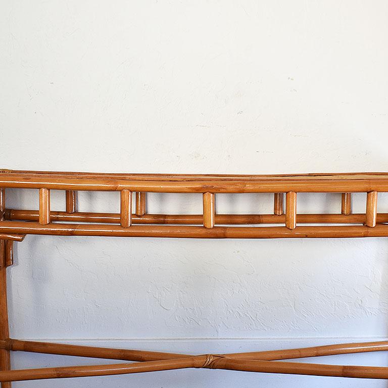 A long bamboo and wicker or rattan console table. This would make a great piece for behind a sofa or in an entryway. The top of this piece features pieces of rattan fashioned into two layers, one on top of each other in diagonal lines. 

The legs