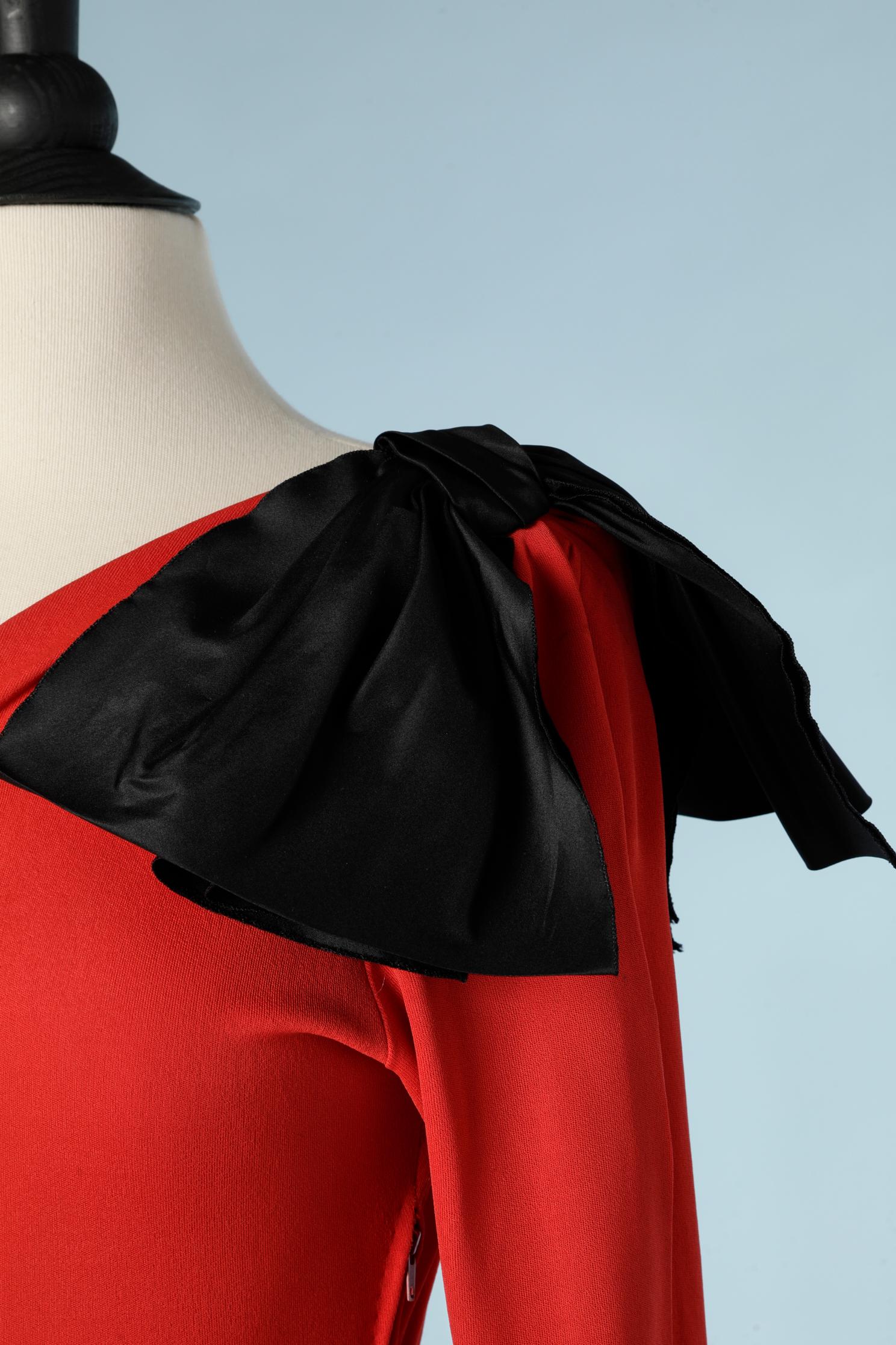 Long red and black asymmetrical evening dress. The top part is in red silk jersey and the skirt in black taffetas. All the  bows in taffetas as well. Ruffles skirt. Rayon lining inside the skirt; 
SIZE 38 ( M) 