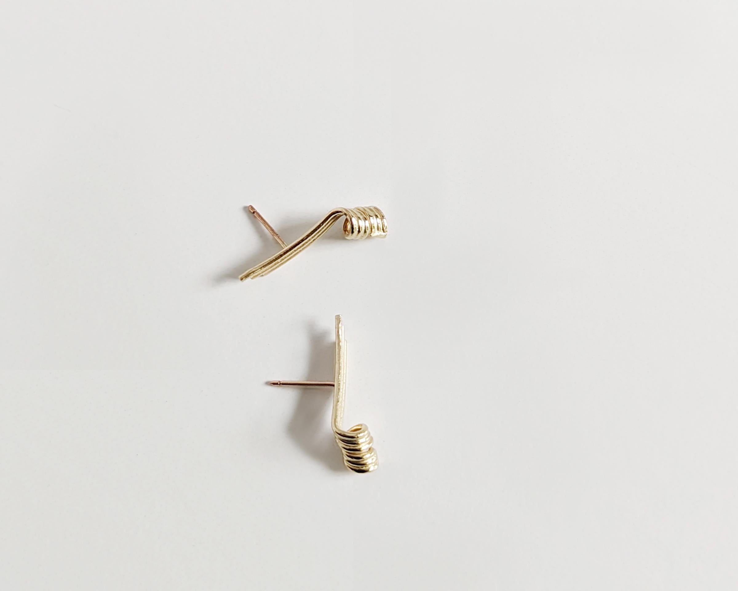 A three-dimensional twist to bar studs… The satisfying curves of spiraling loops rolled into a tubular bar add a unique twist and energy. The corkscrew-style earrings add finesse and effortlessly elevate your outfit.
