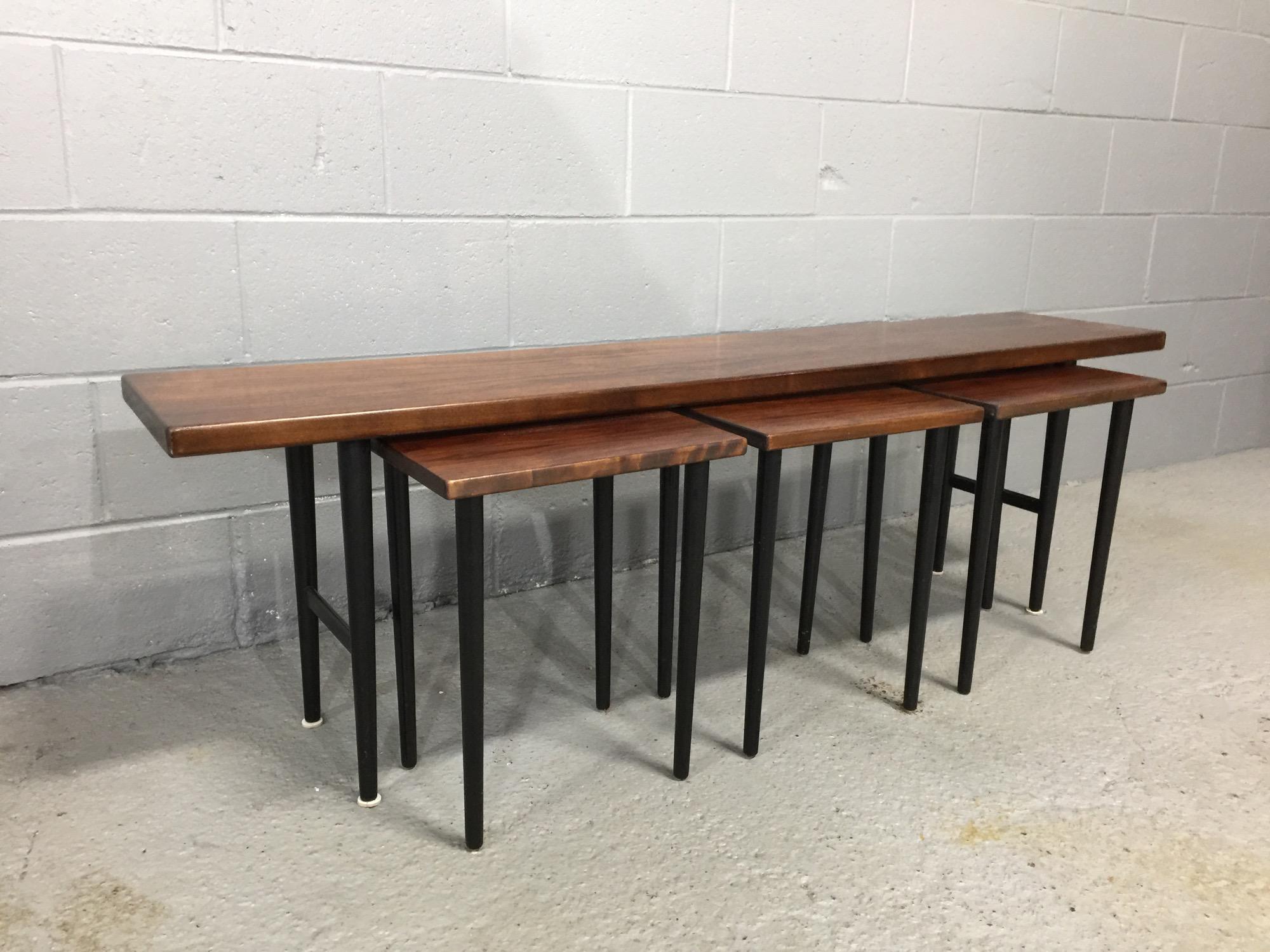 Long rosewood coffee table and 3 small nesting tables.