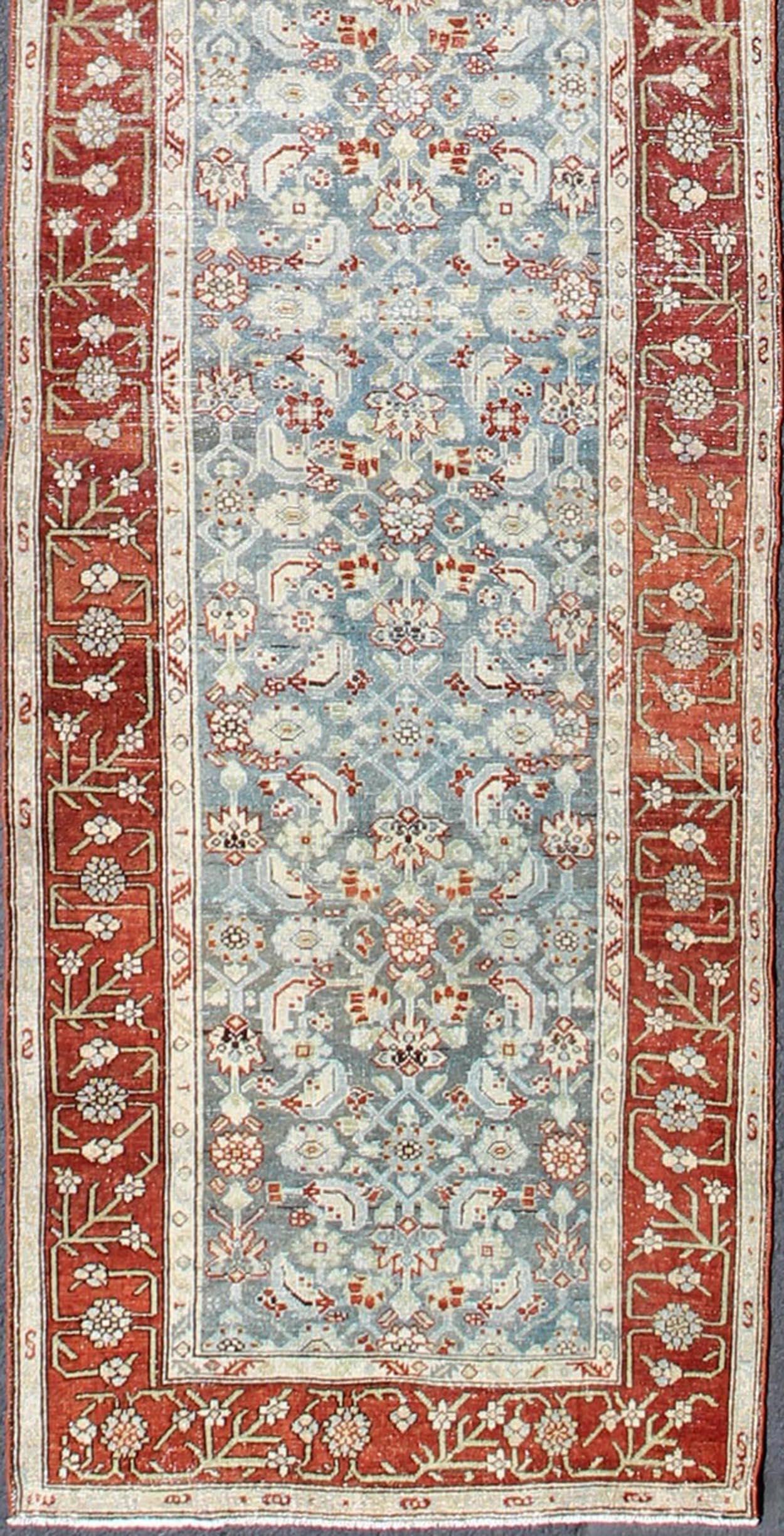 Antique long runner Persian Malayer with all-over intricate floral design in red and blue tones, Keivan Woven Arts/ rug ema-7523, country of origin / type: Iran / Malayer, circa 1910.

This antique Persian Malayer runner, circa early 20th century,