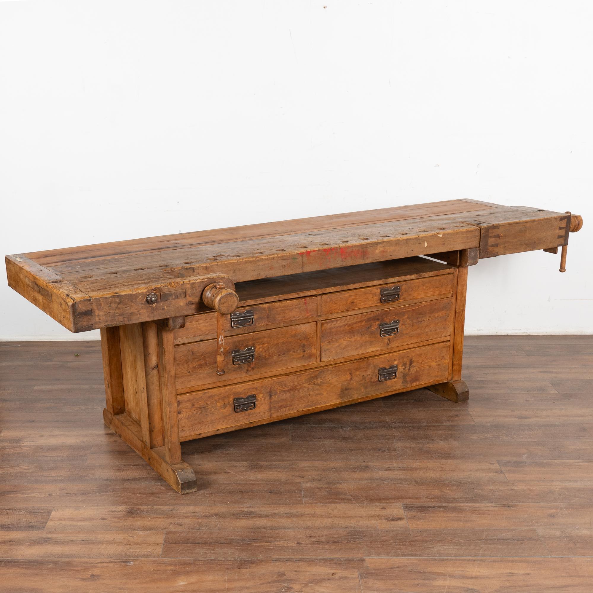 It is the years of constant use revealed in every ding and scratch that enrich the character of this 8' carpenters' workbench from Denmark.
Unique to this workbench are the five large functioning drawers under the table top.
Please examine the close