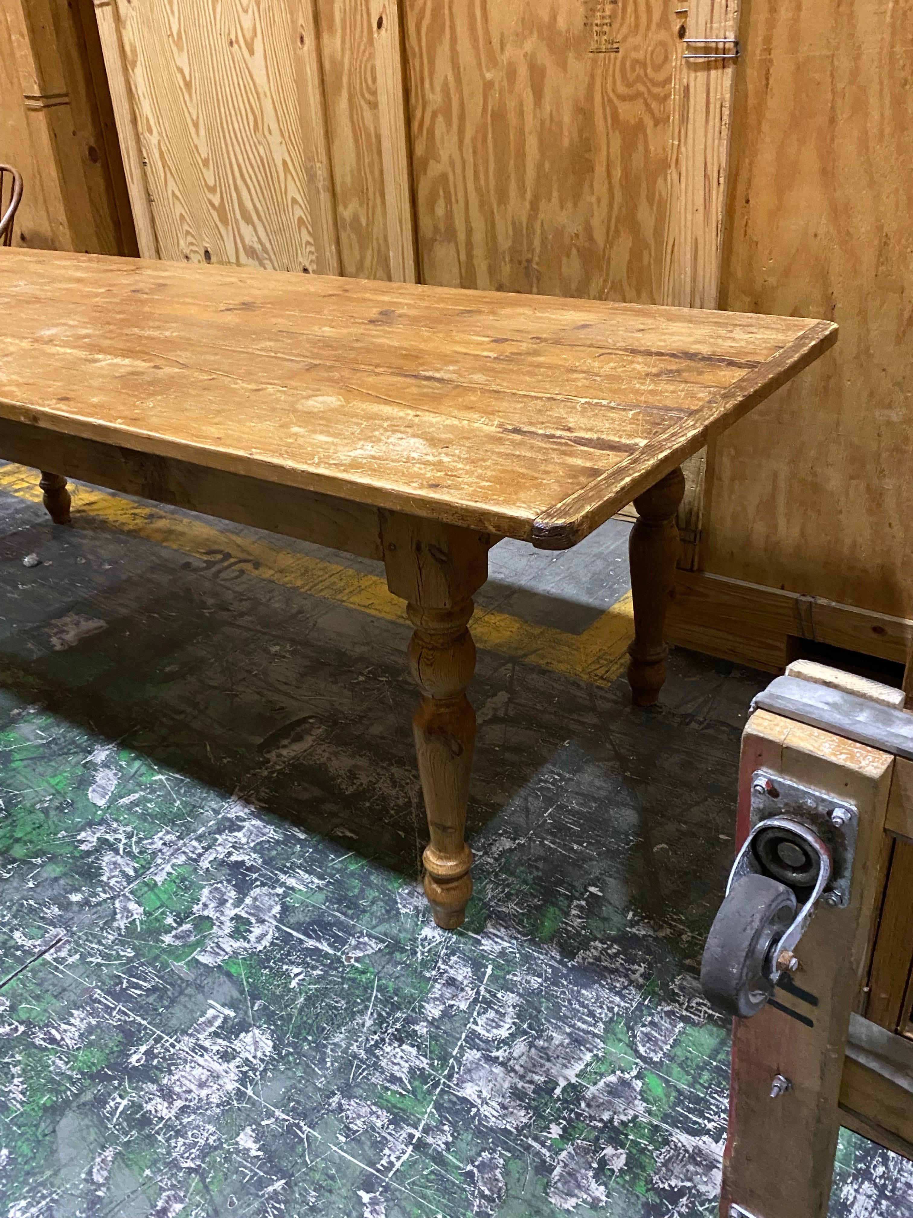 Long Rustic Pine dining table
Great patina and wear, extra long, with lovely turned legs. This is an excellent family dining table. Finish has wear to surface, scratches and scuffs. Structurally sound. 

Measures: 38