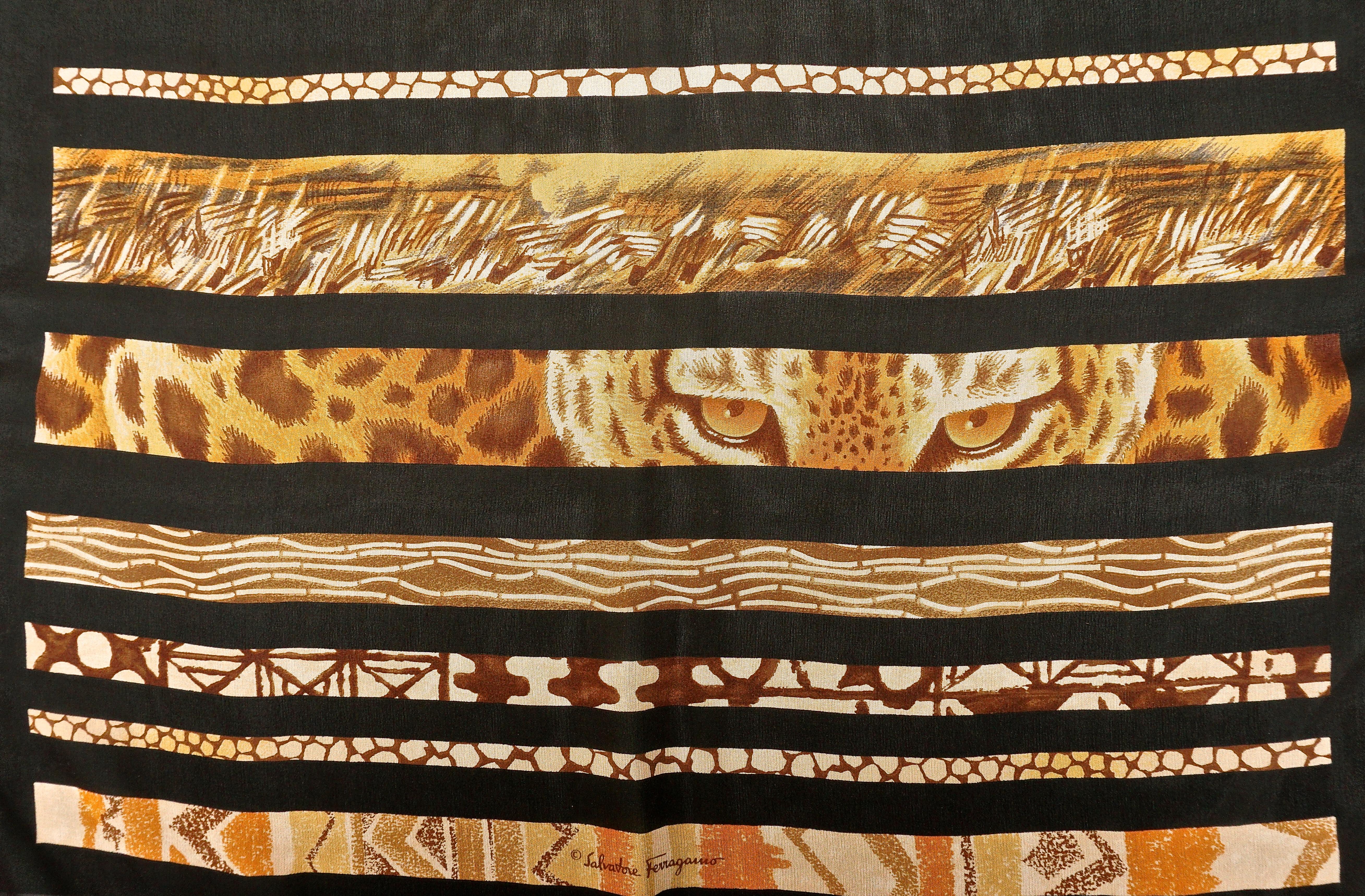 Long Salvatore Ferragamo pure silk chiffon scarf featuring a beautiful striped African print. The scarf is in browns and golds on a black background, and has hand rolled edges. Measuring length 150cm / 59 inches by width 43.18cm / 17 inches. The