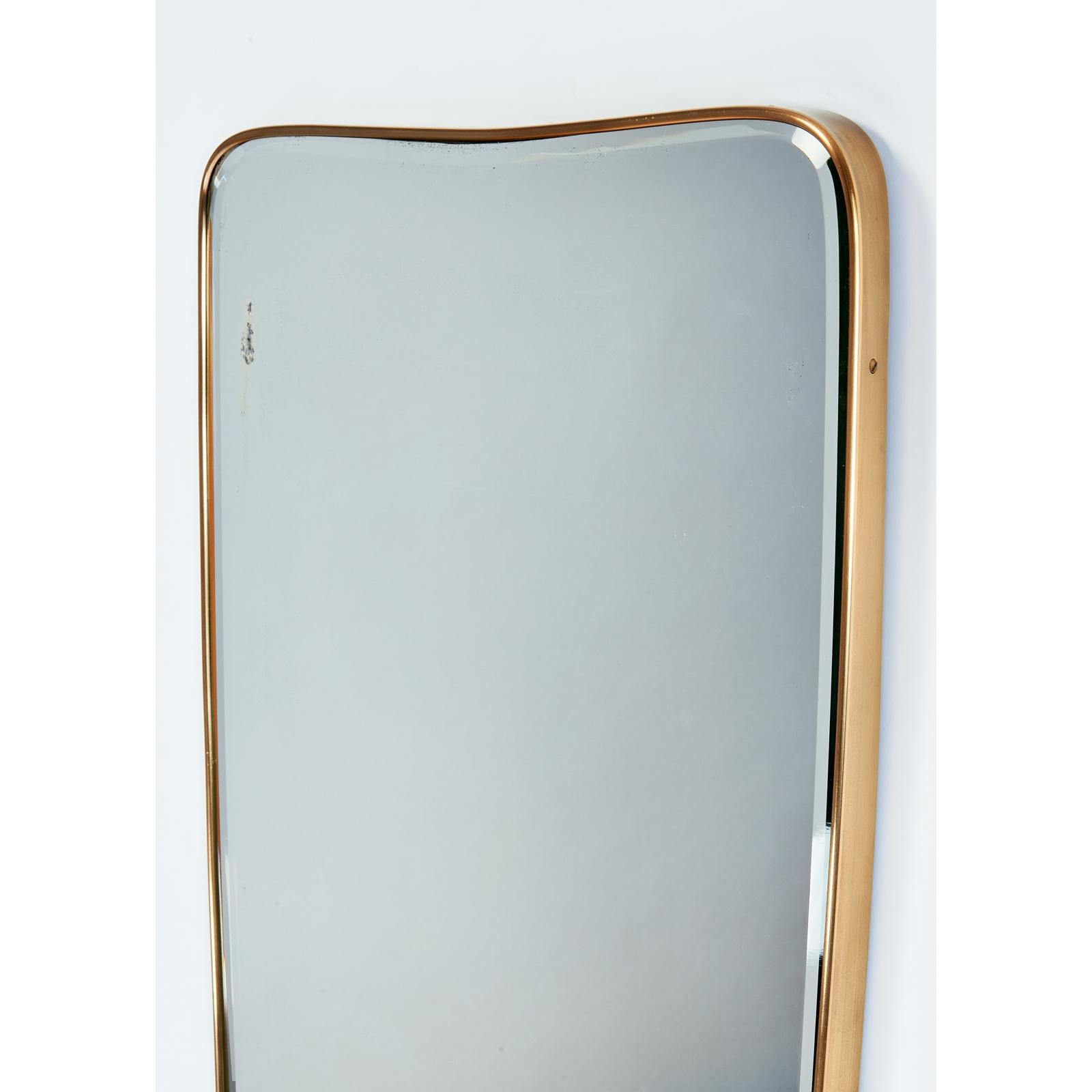 Italy, 1950's
Elegantly elongated shaped polished brass mirror, with beveled glass
Measures: 46 H x 21 W
Mirror has some silvering loss consistent with age, shown on photos.