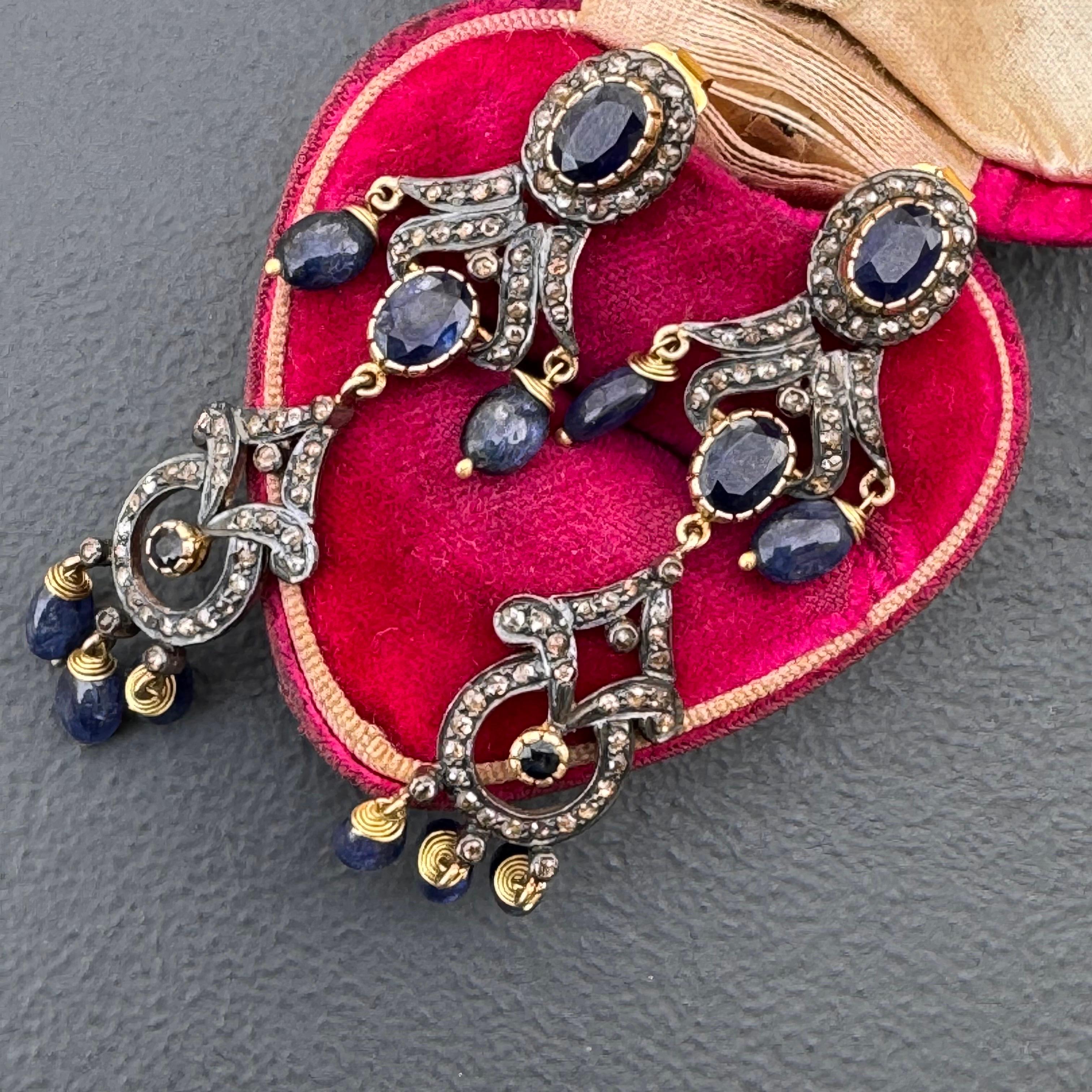 Handmade Victorian style Vintage Silver dangle drop earrings for pieced ears . Most likely earrings are made in India in late 20th to early 21st century with plenty of small rose cut diamonds and genuine faceted sapphire cabs.
Unsigned