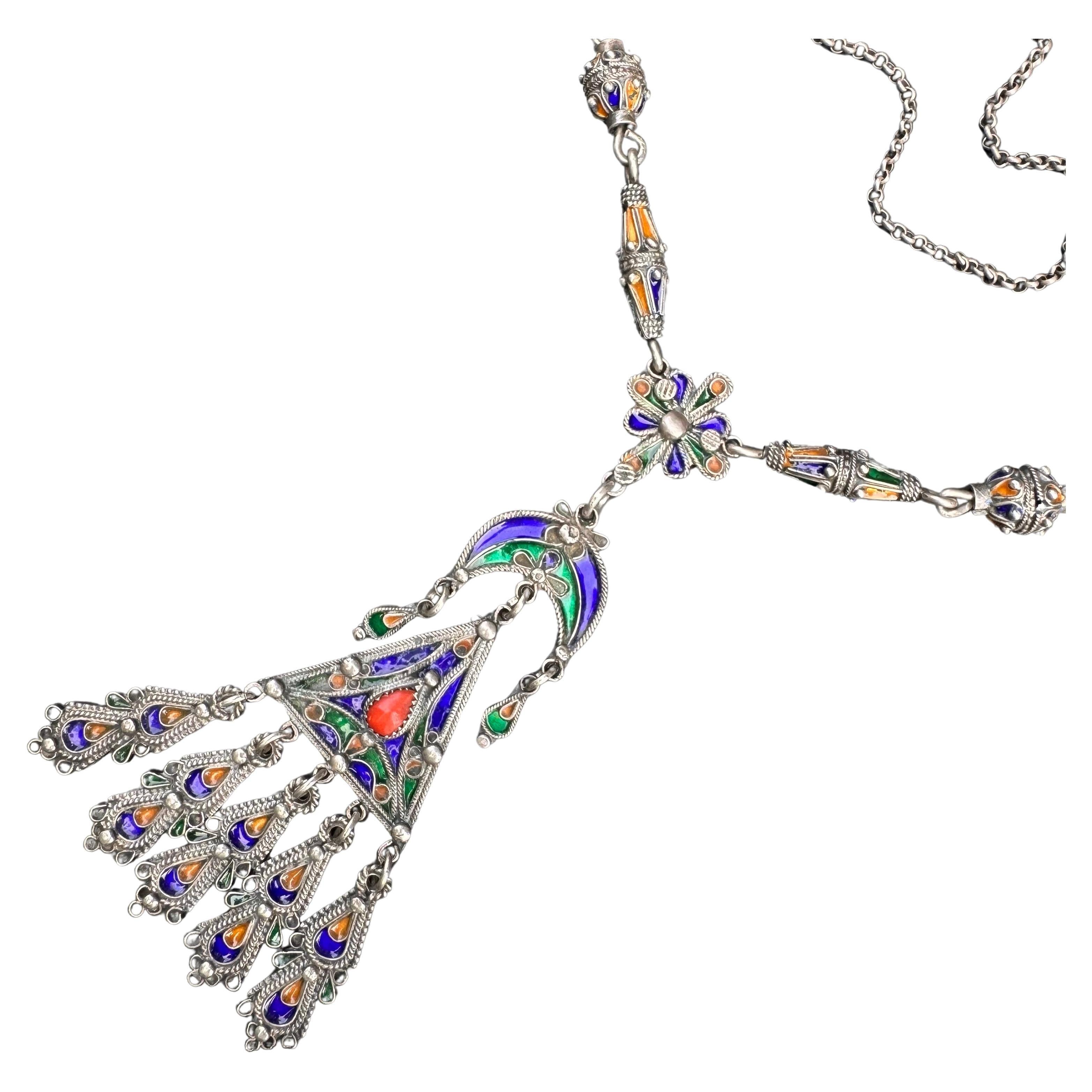 Adorn yourself with this exquisite handmade Berber pendant necklace. Crafted from silver, featuring vibrant enamel and a bold coral accent, showcasing  beautiful ethnic artistry.

Unmarked /unsigned silver ( acid tested for higher grade