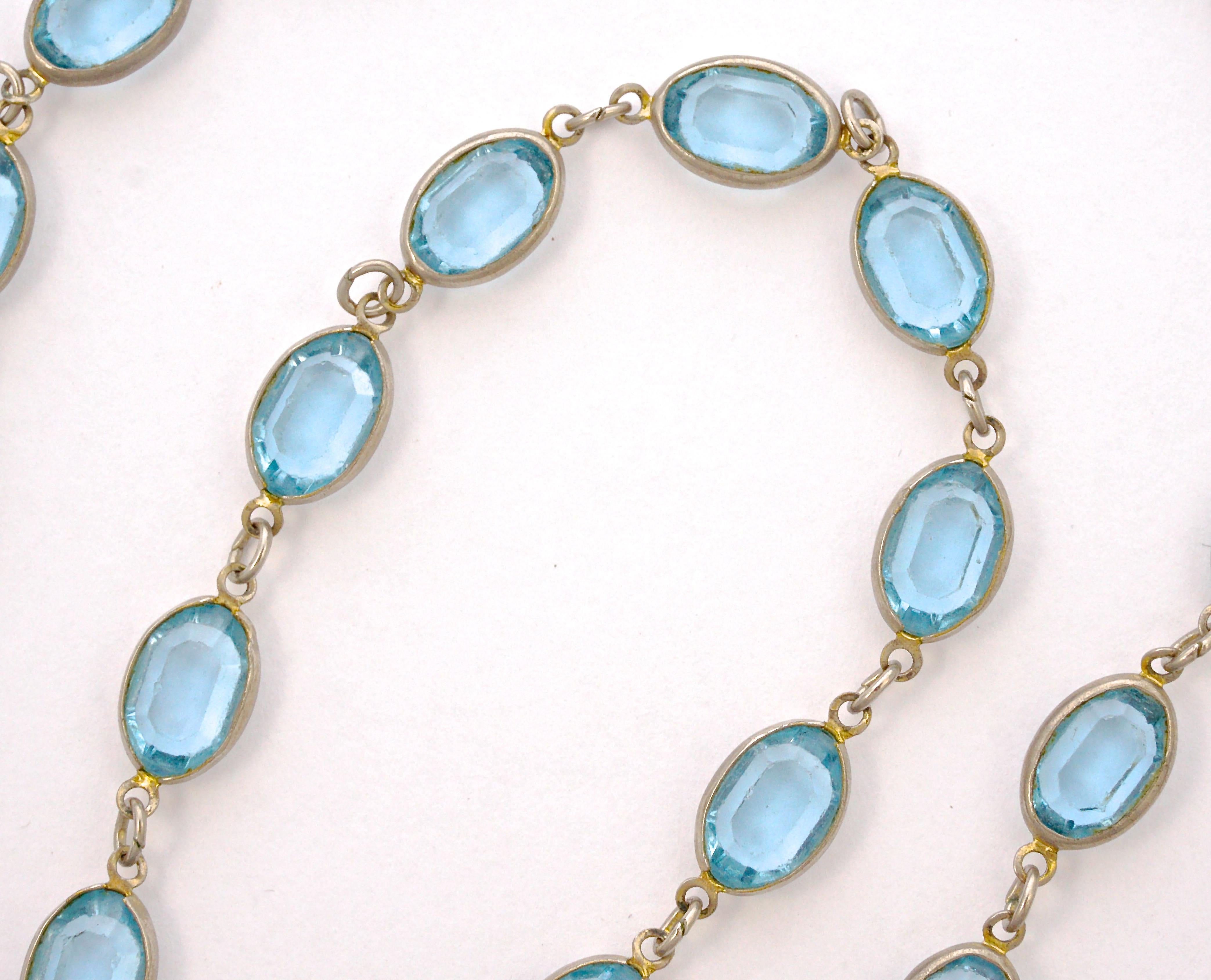 Long silver tone necklace with a spring bolt clasp, featuring lovely bezel set oval blue glass links. The glass stones are faceted and open back to catch the light. Measuring length 125cm / 49.21 inches and the glass jewels measure width 8mm / .31