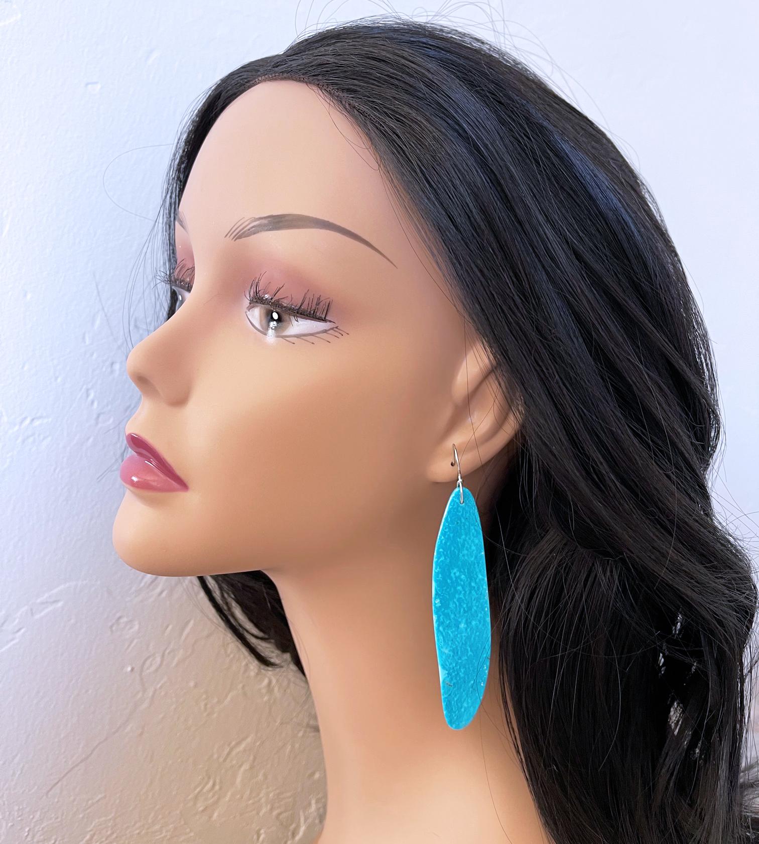 Breathtaking very long sky blue Nacozari turquoise slab cuts were set on sterling silver ear wires to make these stunning one of a kind earrings.  The earrings measure approximately 3.5 inches (8.9 cm) long from top to bottom. The intense blue color