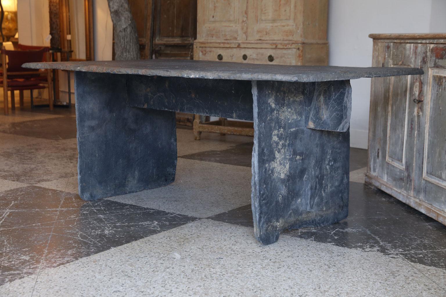 Long slate dining table, or console, with rectangular heavy, thick slate top with three-piece slate trestle base.
  