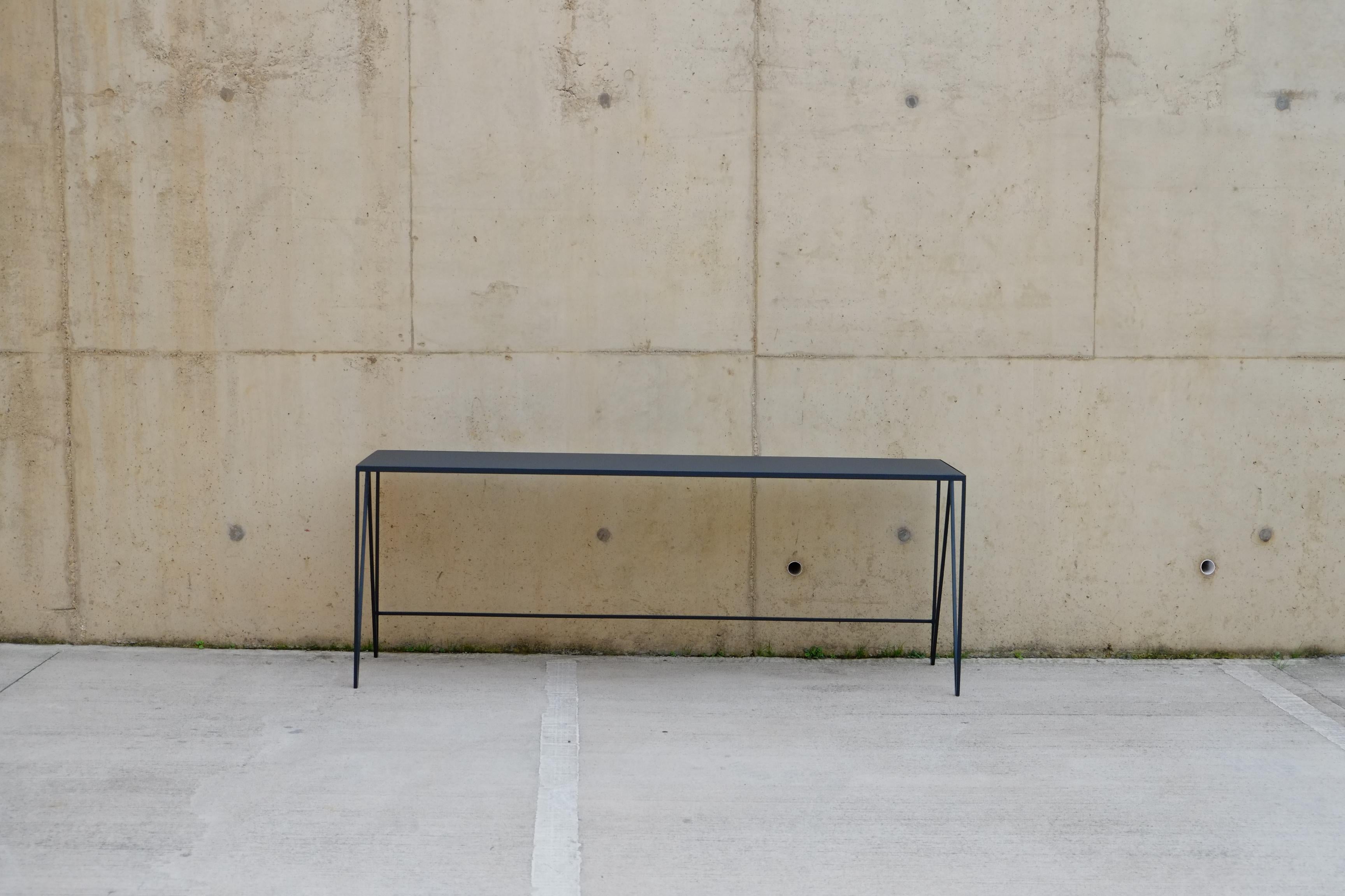 This large Study desk / Console Table  is made with a charcoal black powder-coated steel frame and a charcoal linoleum top made from all-natural ingredients, such as flax, wood flour, and limestone. The furniture linoleum provides a natural matt