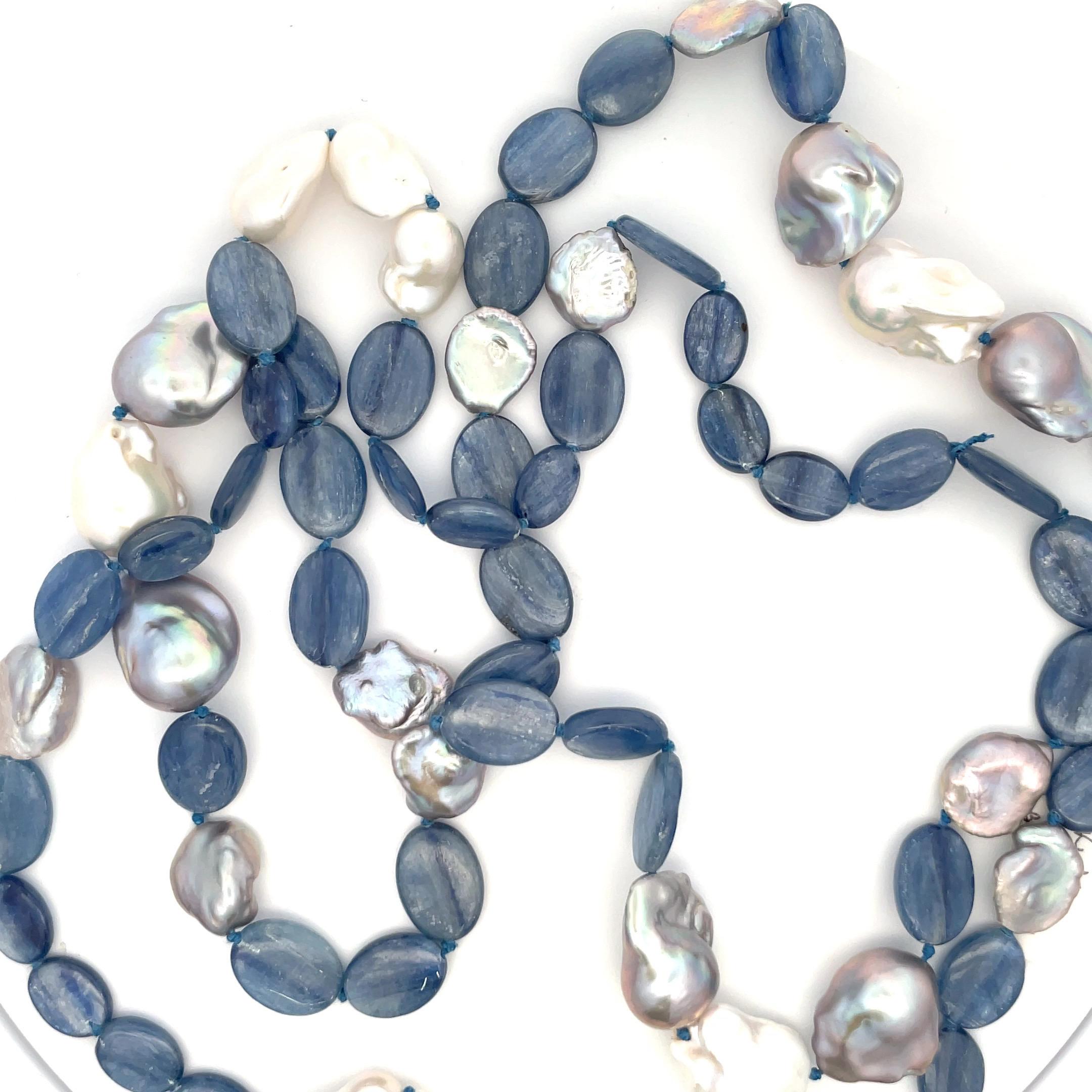 Long strand of Kyanite gemstone with touches of Keshi and Baroque white and grey color pearls, measuring 50 inches. 