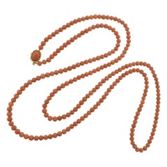Long Strand of Natural Coral Finished with a Fine Gold Clasp, circa 1950