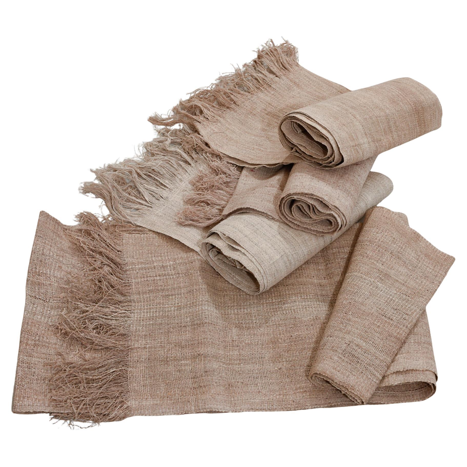 Long strips of hemp in different shades. They can be unusual curtains to divide a room. 
On the floor there could be a mat in natural écru color. Look at the ones I posted: écru kilim, camel, field, natural color..

rif. O/5159