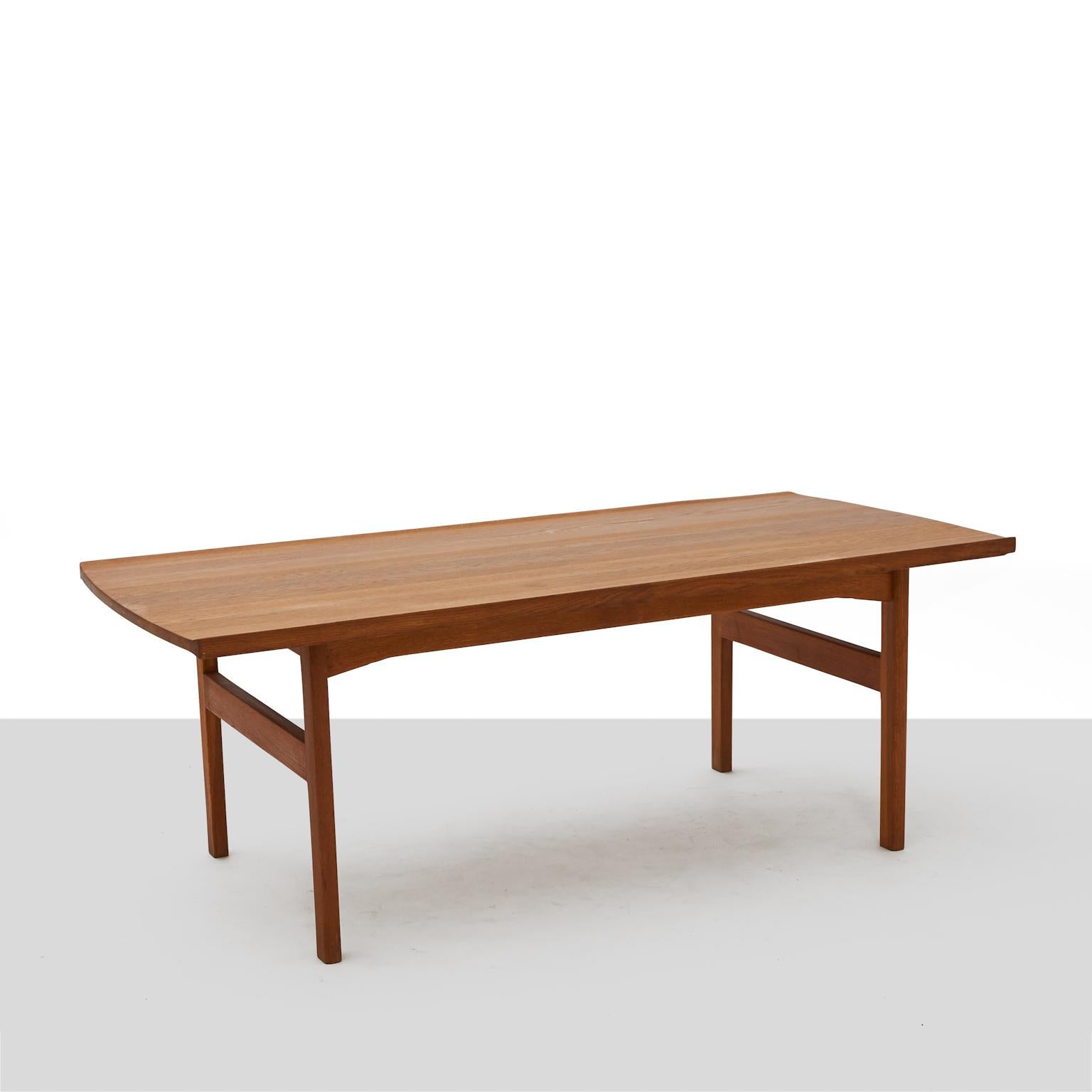 A coffee table of solid teak with upturned edges running the length of the table by Tove & Edvard Kindt-Larsen. Manufactured by and marked for AB Seffle Furniture.