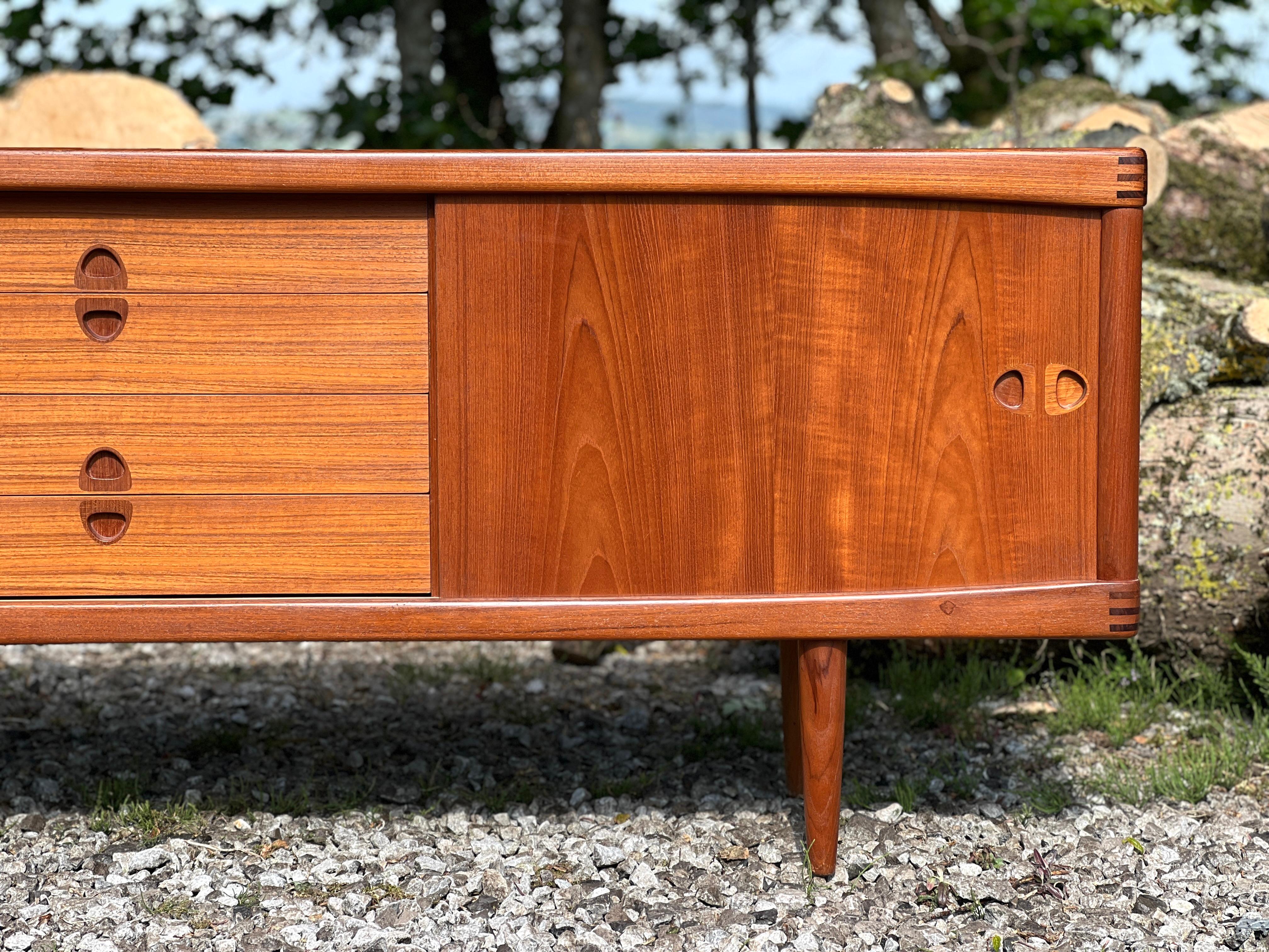Henry Walter Klein designed this beautiful piece in the ’60s in Denmark for the well-known high-quality cabinet maker Bramin.

The sideboard has a balance designed with a bank of drawers in the middle and two sliding doors enclosing shelves. The top