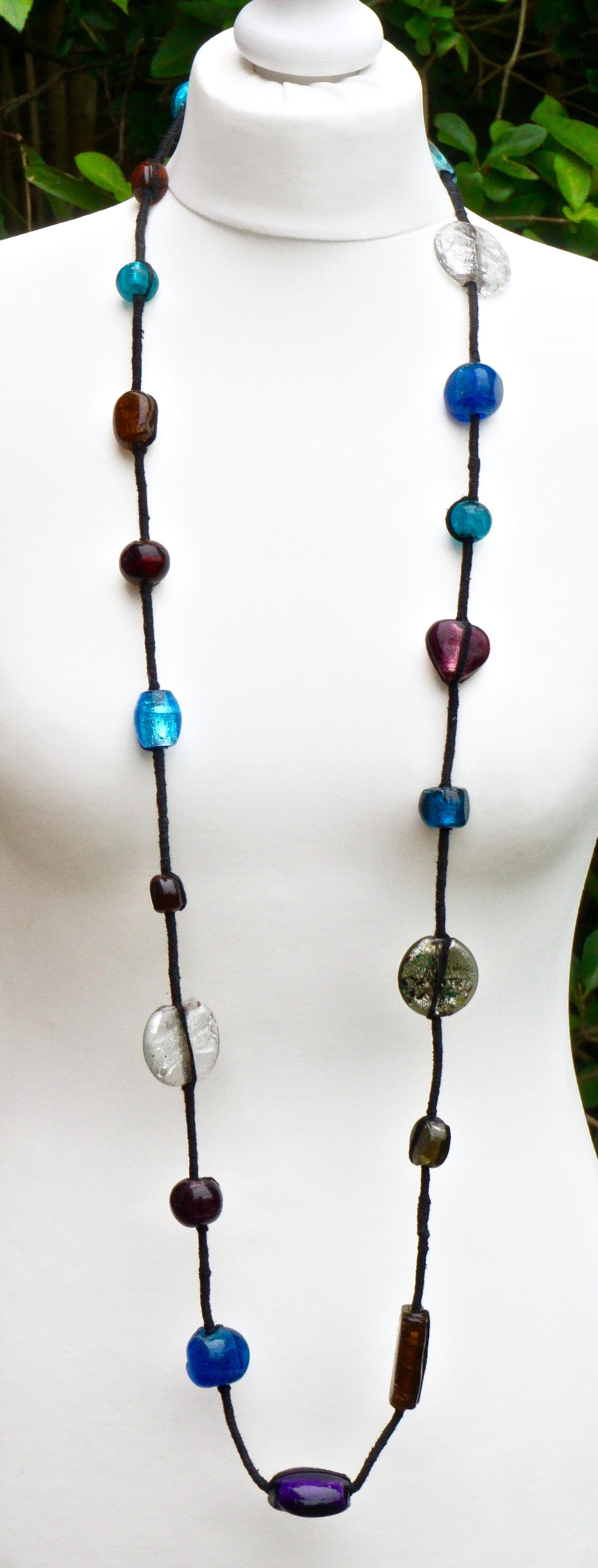 Long Tibetan necklace featuring beautiful hand made foiled art glass beads on woven black thread. The beads are of different sizes, shapes and colours. Length 134cm / 52.75 inches, and the large white beads are 3.5cm / 1.38 inches by 3cm / 1.18