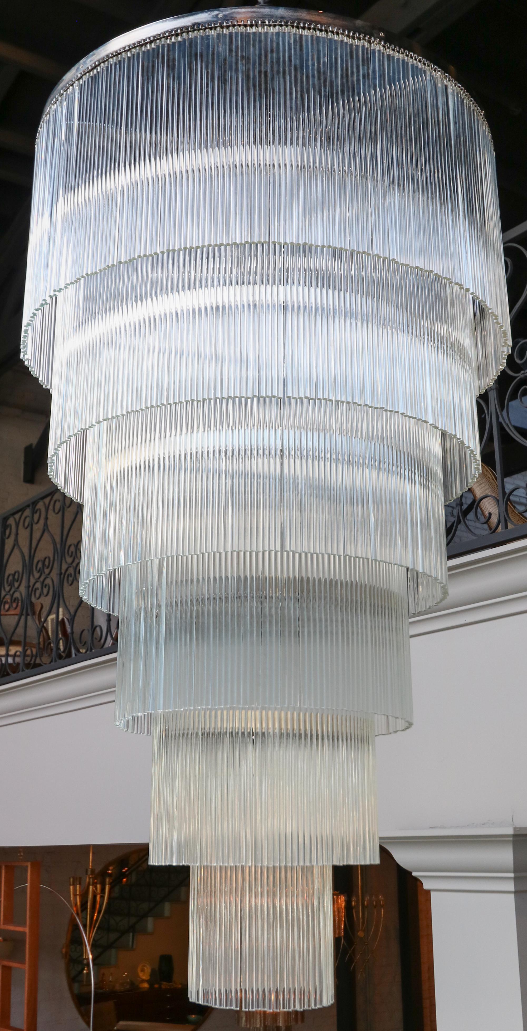 Long chandelier with six tiers with over a thousand glass rods on a chrome frame.