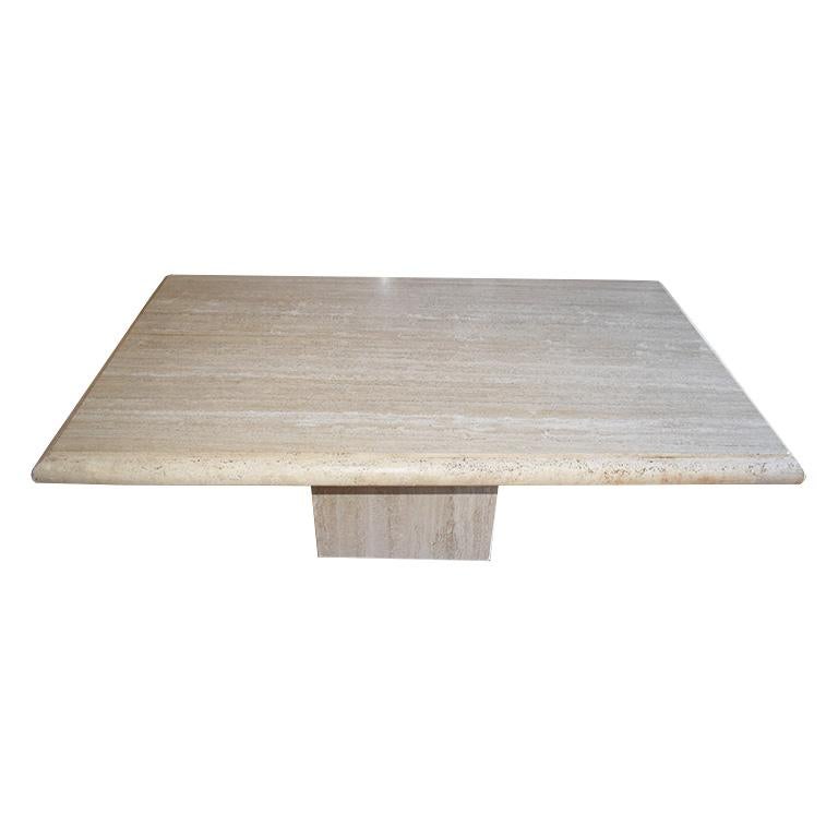 Long natural travertine stone dining table with heavy rectangular top, and box travertine bottom. The top of this beautiful dining table is carved from a single slab and features a smooth finish and very thick 3