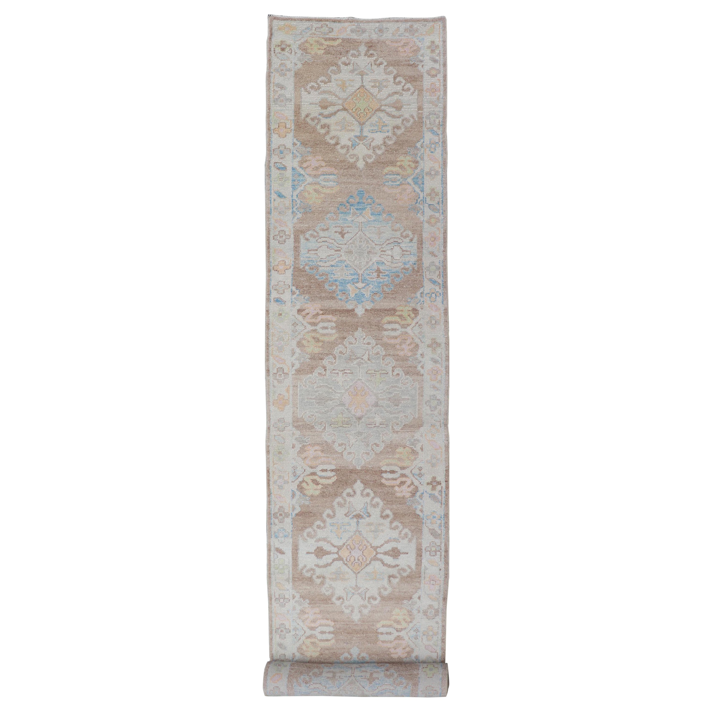 Long Turkish Oushak Runner with Pale Blue, Soft Yellow, and Light Brown Motifs