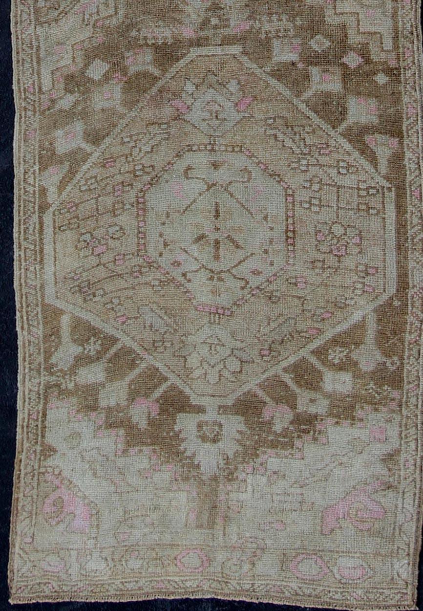 Vintage Oushak Runner from Turkey with vertical medallion design in brown, wheat, lavender pink, ivory, tones, rug en-176011, country of origin / type: Turkey / Oushak, circa 1940

This beautiful vintage Oushak runner from 1940s Turkey features a