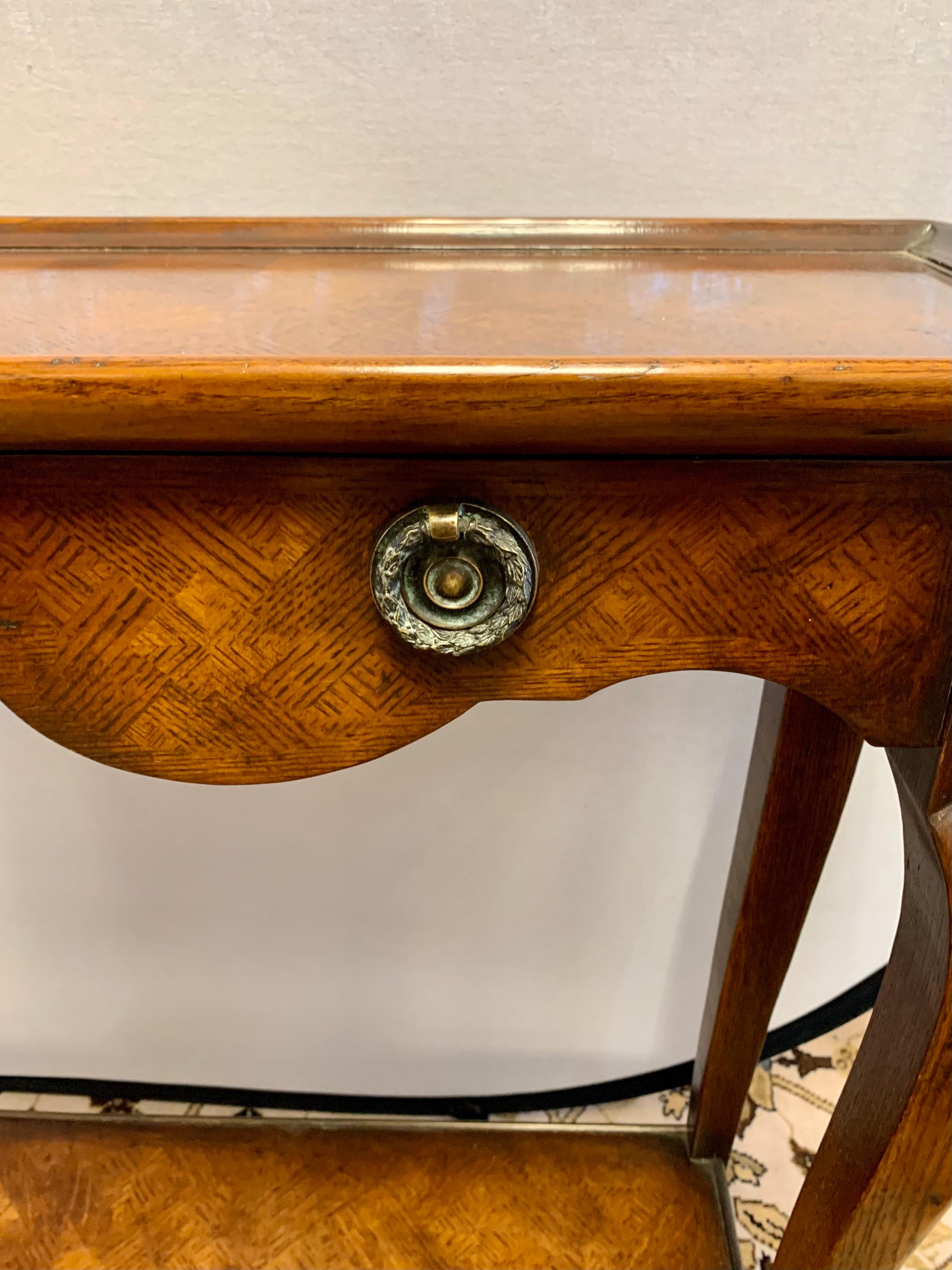 Elegant walnut four drawer console table with two tiers. Elegant Robsjohn round style hardware and parquet like finish make this console stand out.