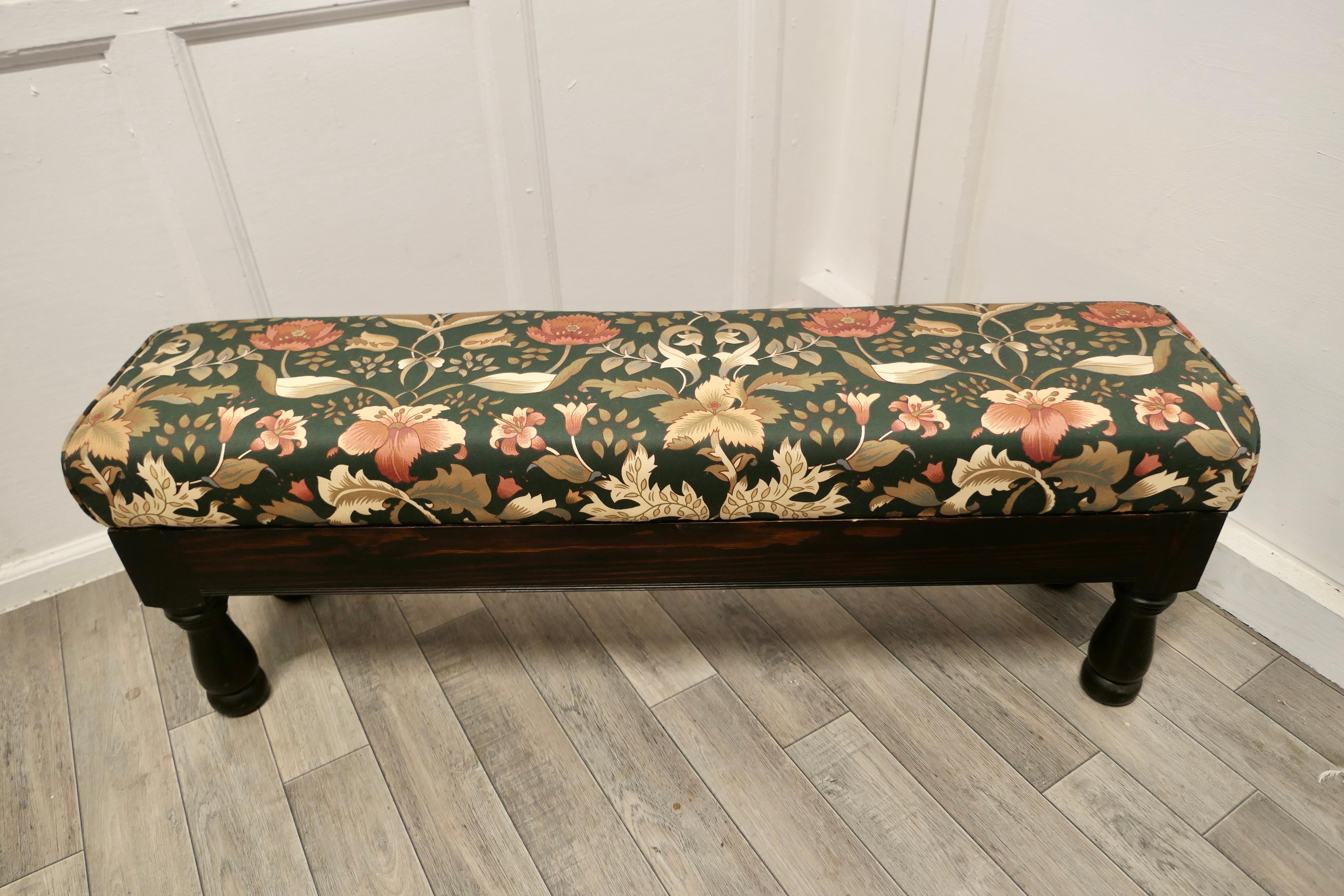 Long upholstered window seat stool.

A very attractive piece, the seat has new William Morris style floral print linen upholstery.
This would make a lovely window seat or boudoir stool and it is in good condition. 
The stool is 45” long x 11”