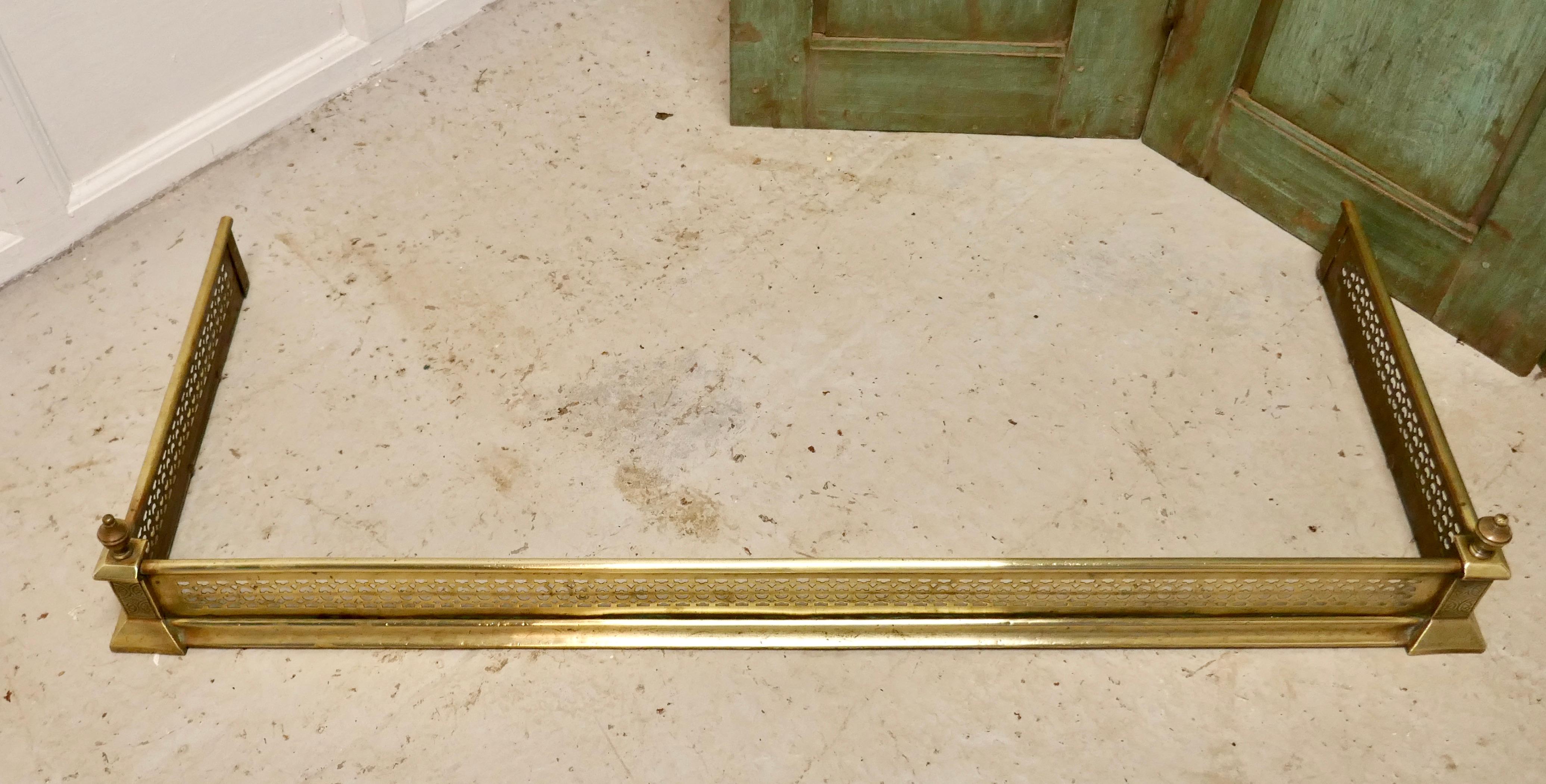Long Victorian pierced brass fender

This is a top quality Victorian pierced brass fender it has a pierced decoration along the front with elegant turned and engraved finials at each end
The fender is in good condition it is 7” high, and 44” long