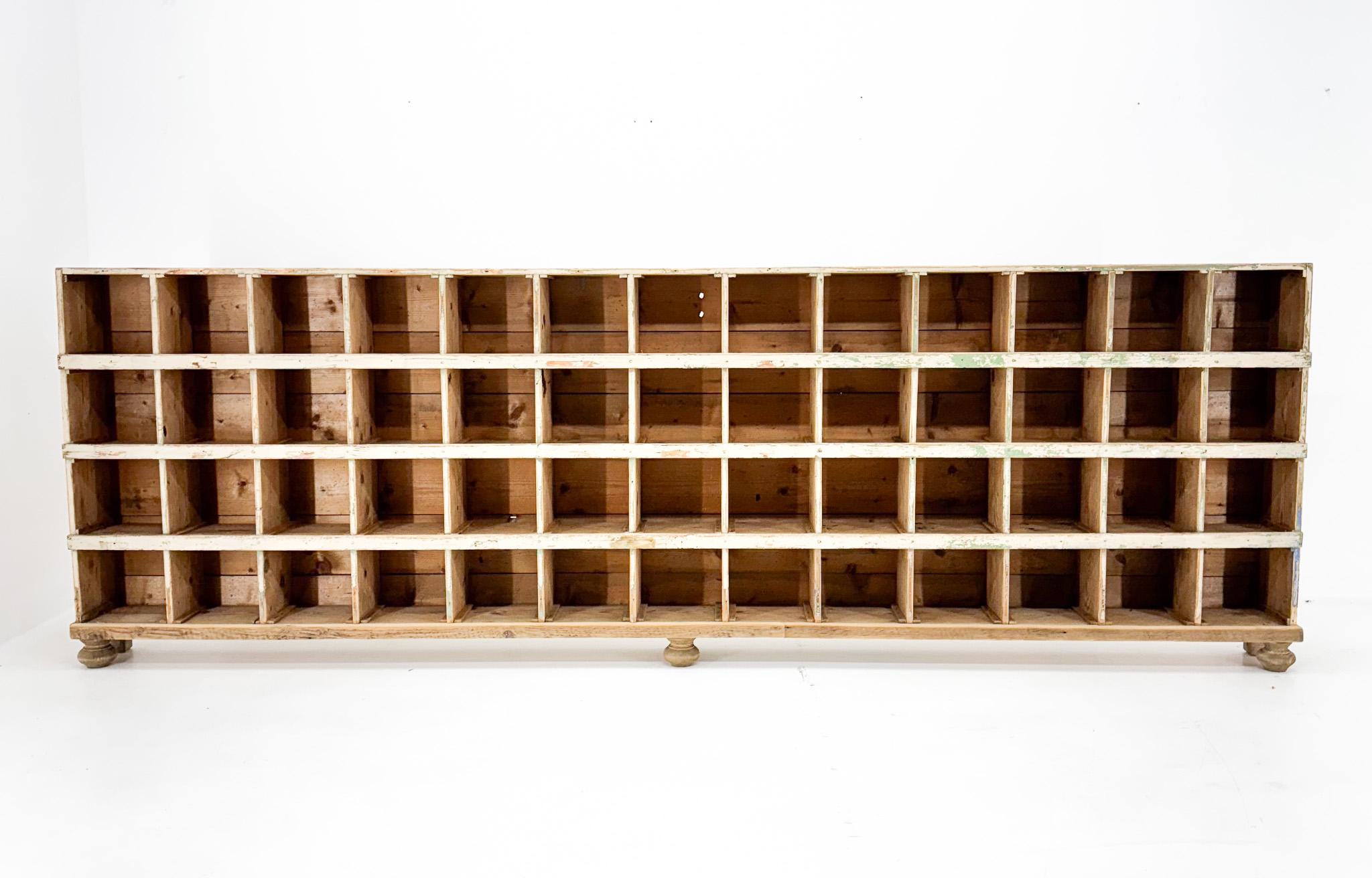 Unique wooden long cabinet with 52 compartments. Original condition, new front legs. The internal dimensions of each compartment are 21 x 20 cm.
