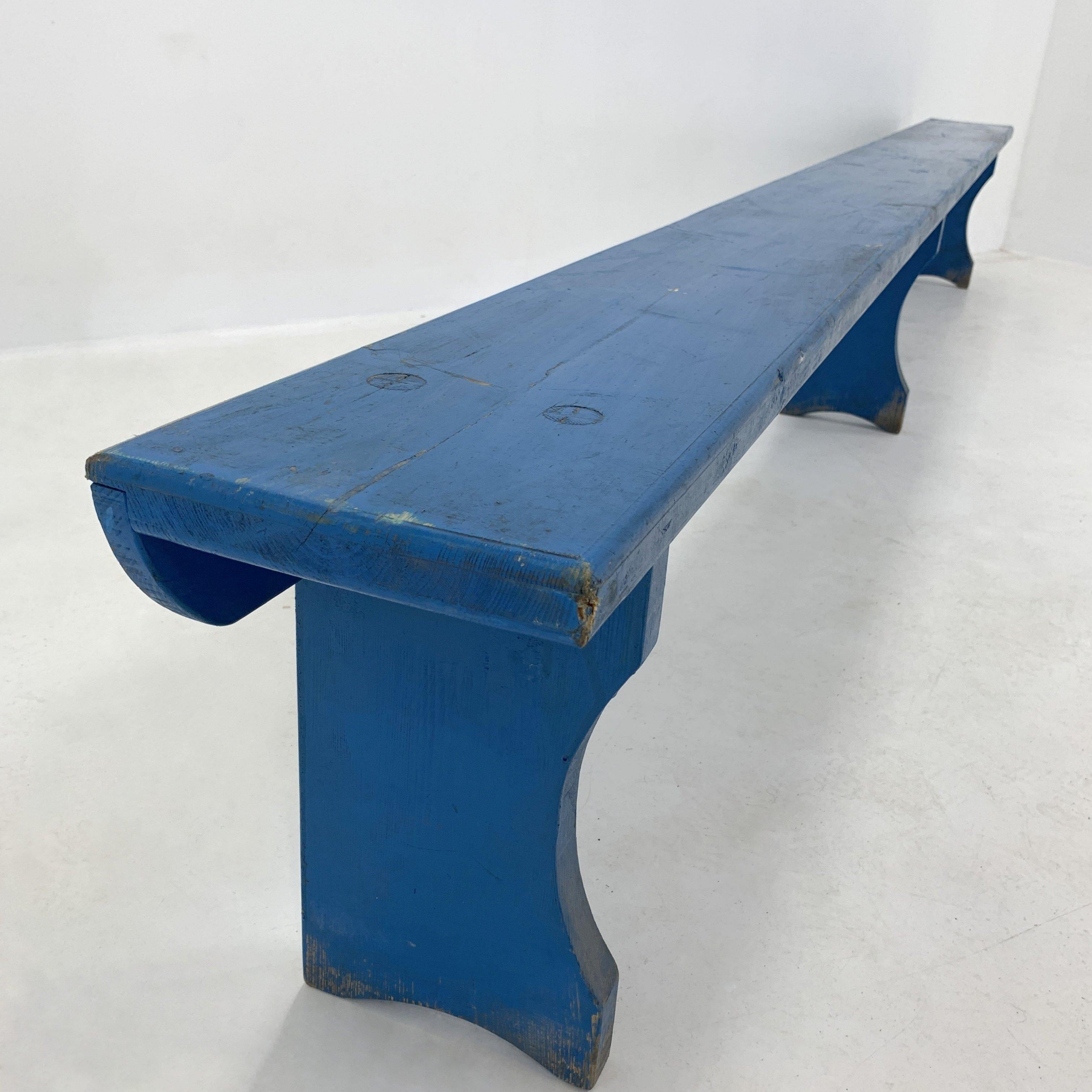Long vintage all-wood bench from an elementary school in former Czechoslovakia from 1930s with its original paint.