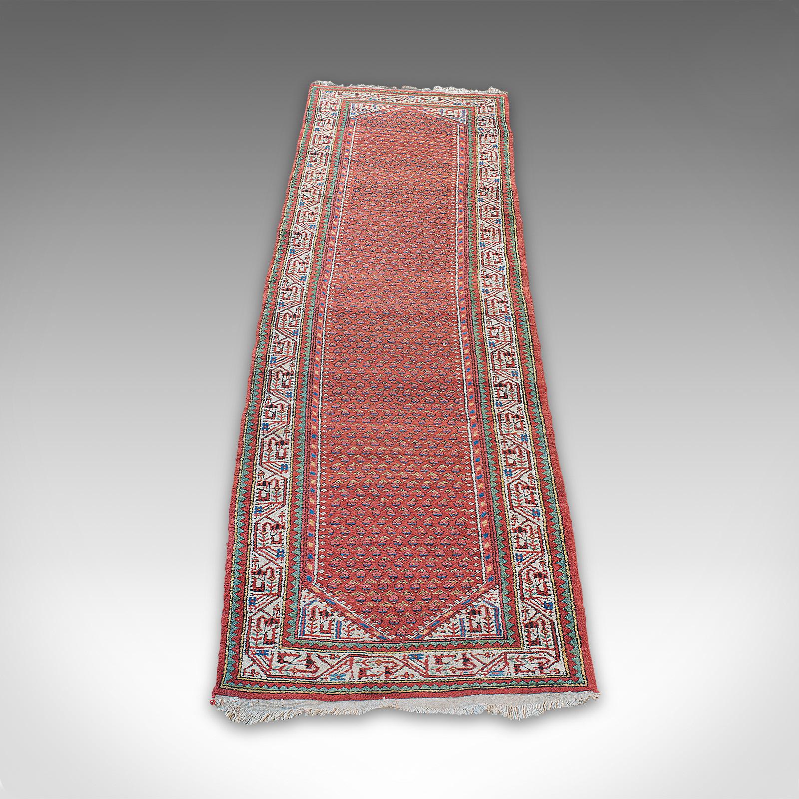 This is a long, vintage hallway runner. A Persian, woolen hall carpet, dating to the mid 20th century, circa 1960.

Generously sized runner at 83cm x 310cm (2.72' x 10.17')
Add a warm texture and great colour to the hallway
Displaying a