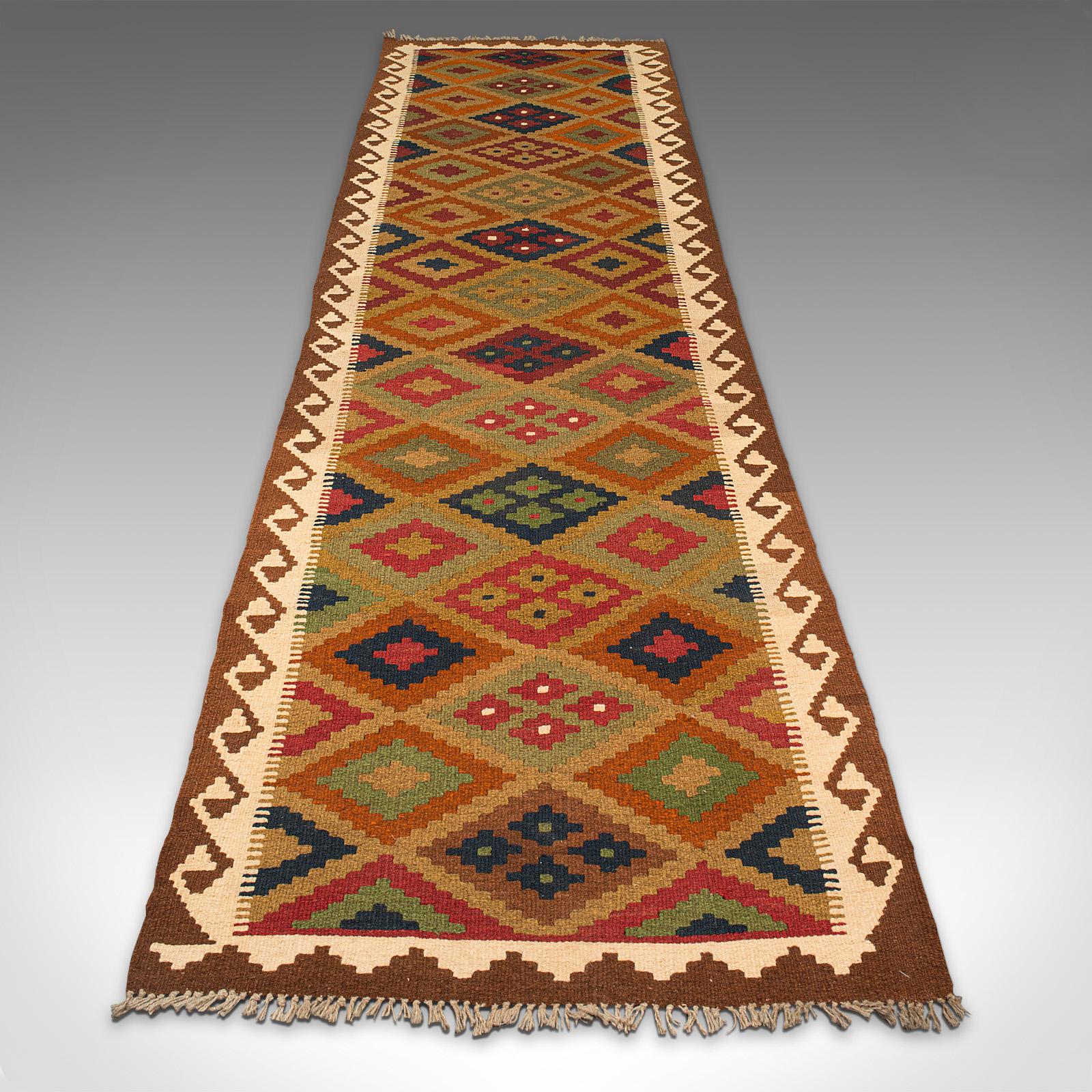 This is a long vintage Maimana Kilim runner. A Caucasian, woven decorative carpet or hallway rug, dating to the late 20th century, circa 1990.

Delightfully sized for the larger reception hall at 83cm (32.75'') x 299cm (117.75'')
Displays a