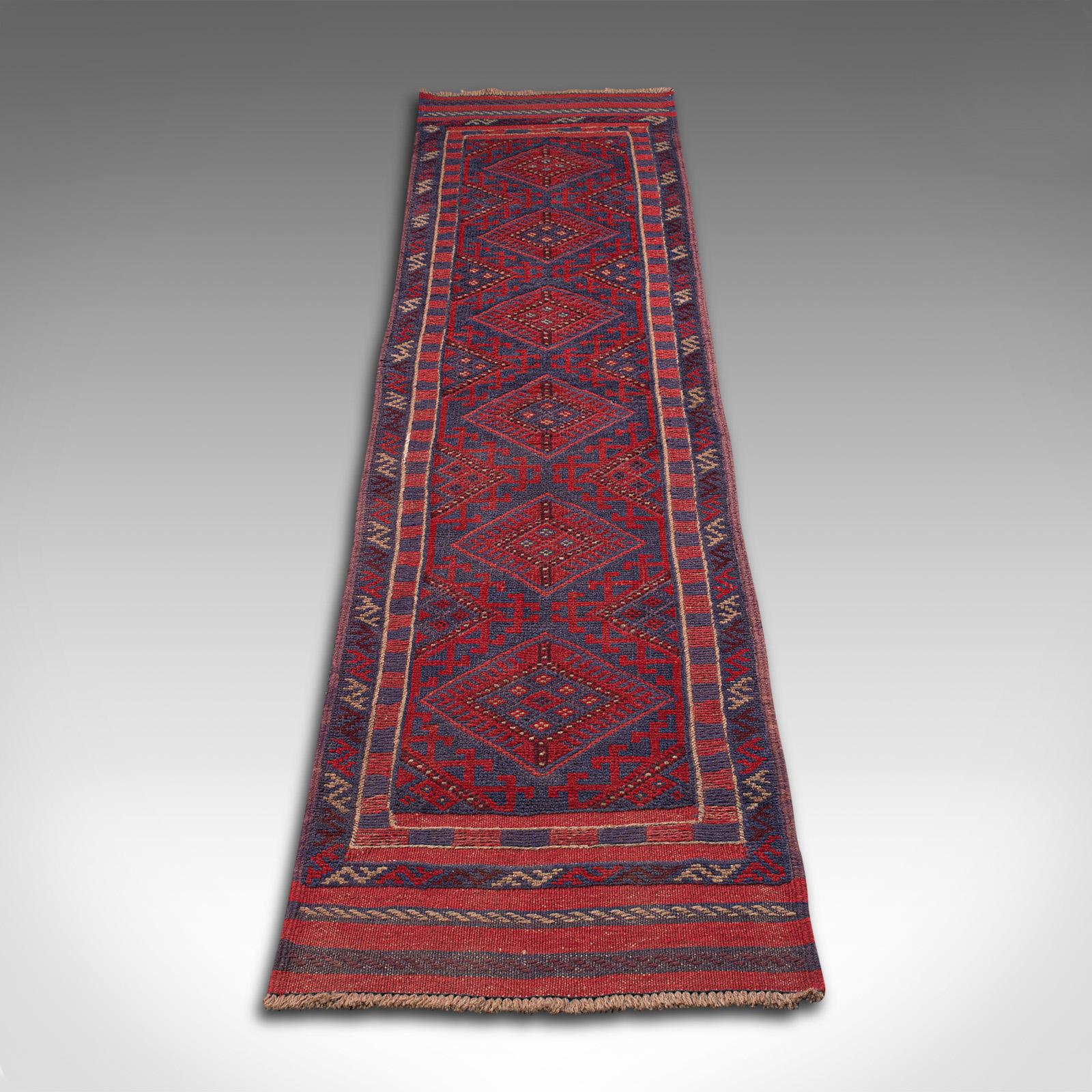 This is a long vintage Meshwani hallway runner. A Caucasian, woven rug or hall carpet, dating to the mid 20th century, circa 1960.

Of useful reception hall size at 61cm x 273cm (24