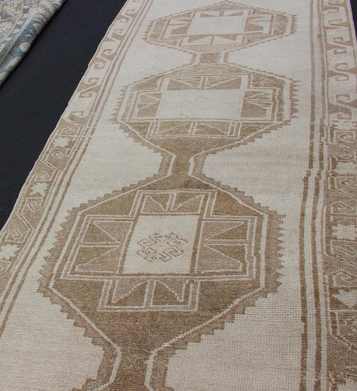 20th Century Long Vintage Turkish Oushak Runner with Medallions in Creams and Tans For Sale