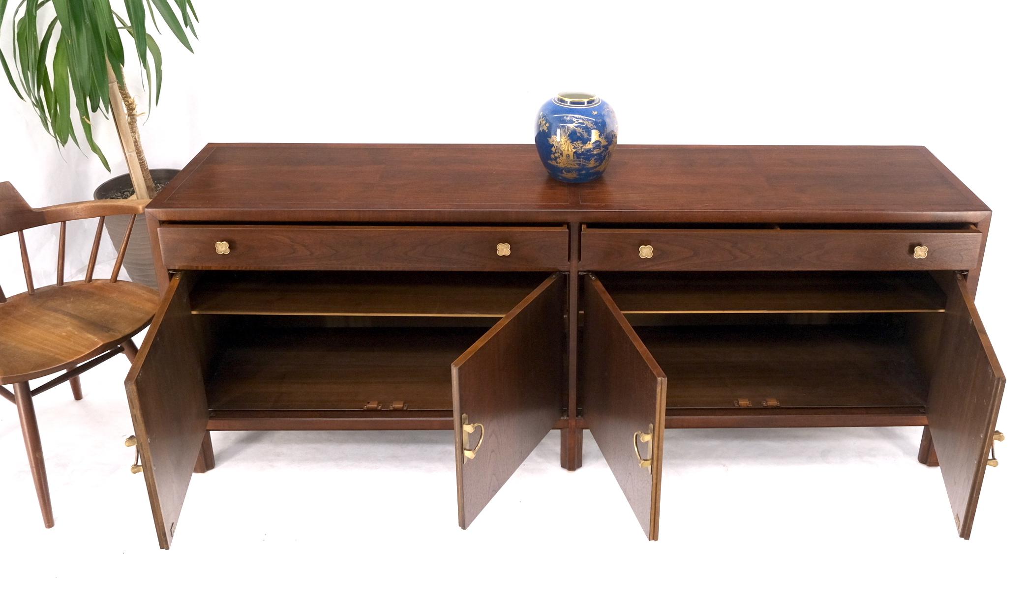 Tri legged base rounded triangular shape carved walnut stand lamp candle table.
Fully restored condition. Gorgeous solid brass buckle shape pulls. Two long drawers and pair of double doors compartments with adjustable shelves.