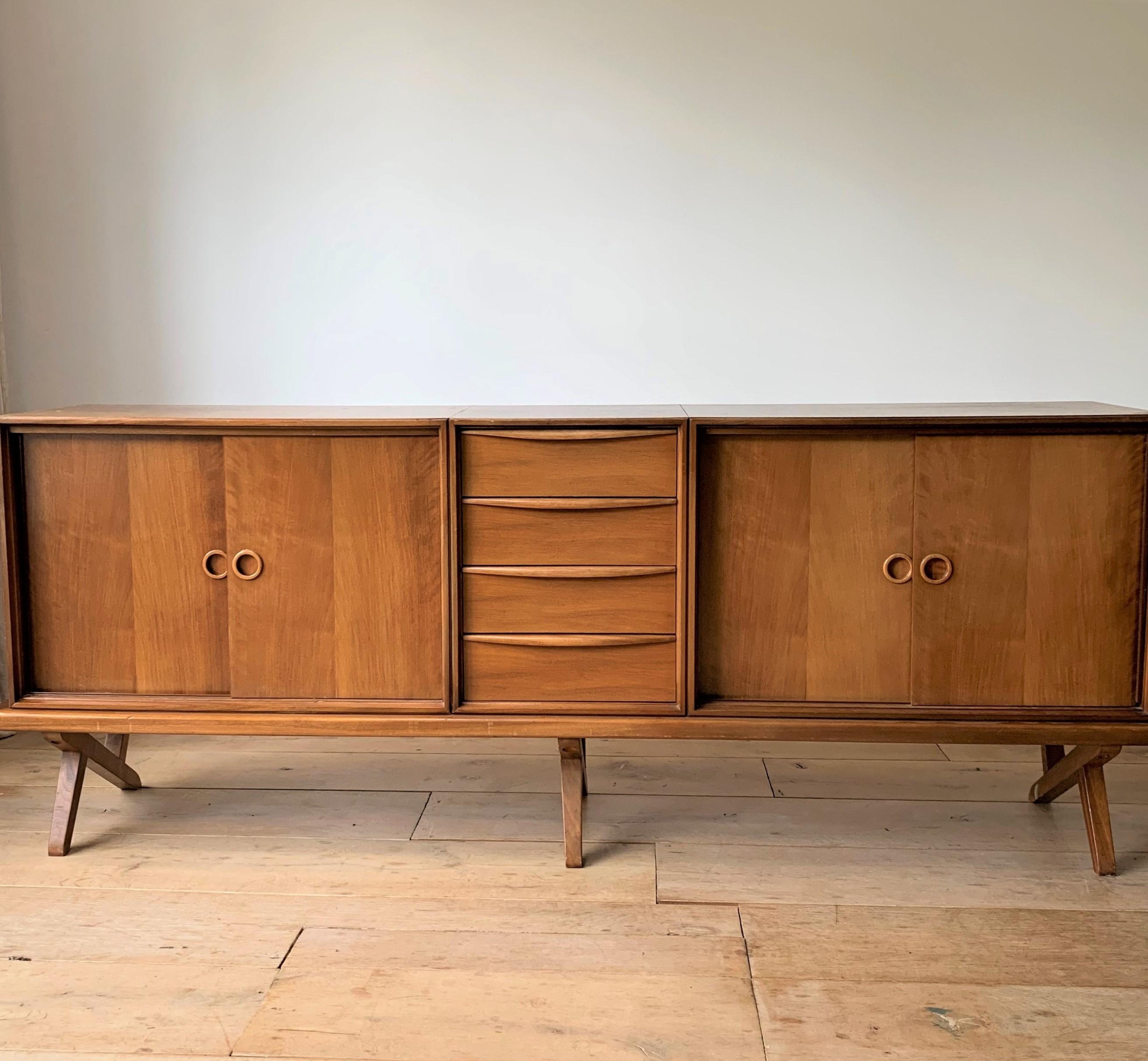 Rare, one in it's kind credenza designed by Rudolf Bernd Glatzel and manufatured by Fristho Franeker, Holland 1955. This nice large credenza has a drawer compartment in the center and 2 side compartments with sliding doors , these have one shelve in