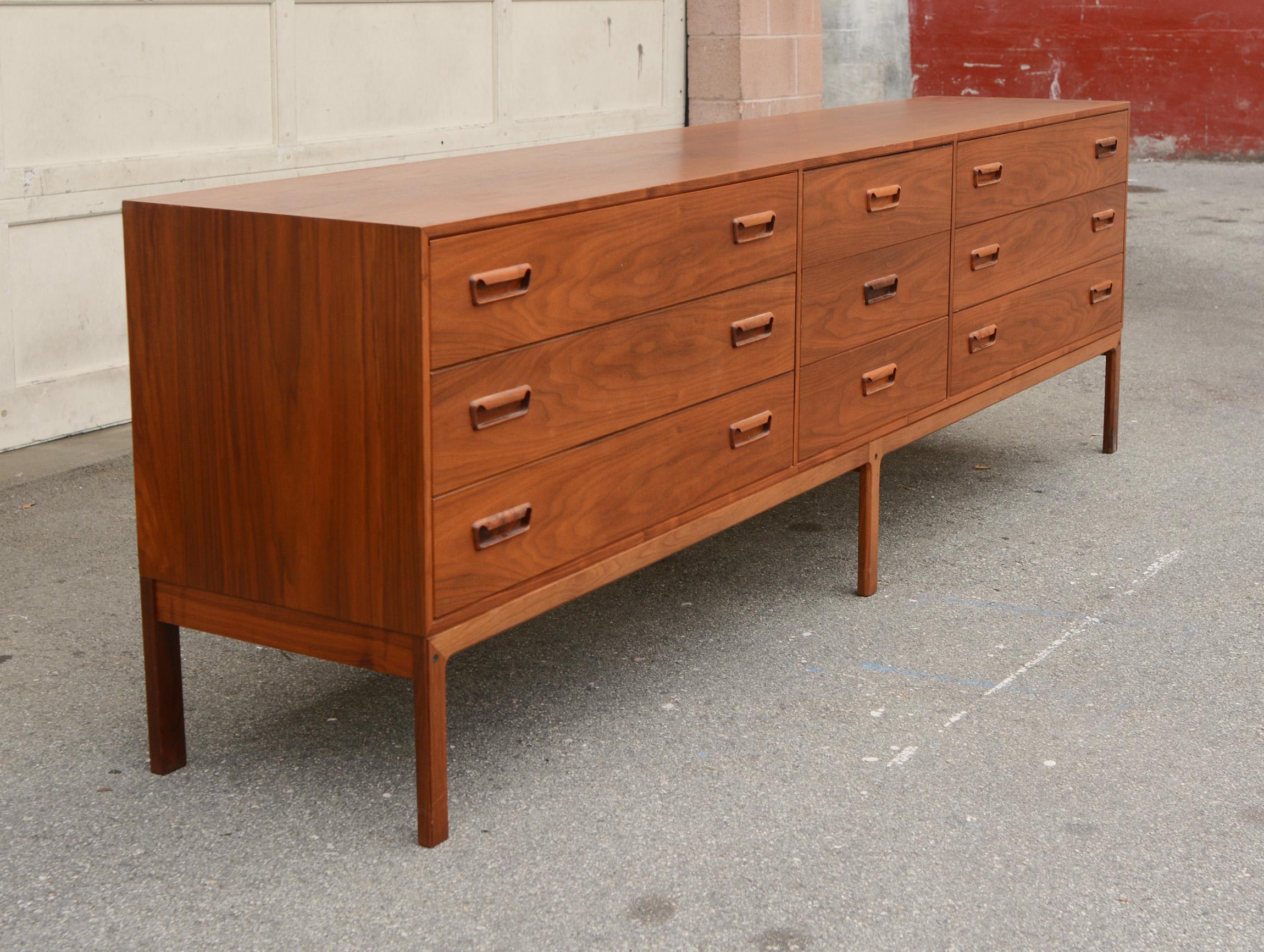 Long triple chest of drawers by Arne Wahl Iverson for Vinde Mobelfrabrik. This has a tremendous amount of storage for a los chest. This chest is walnut with an outstanding grain pattern. The finish is original and in very good condition. There are a