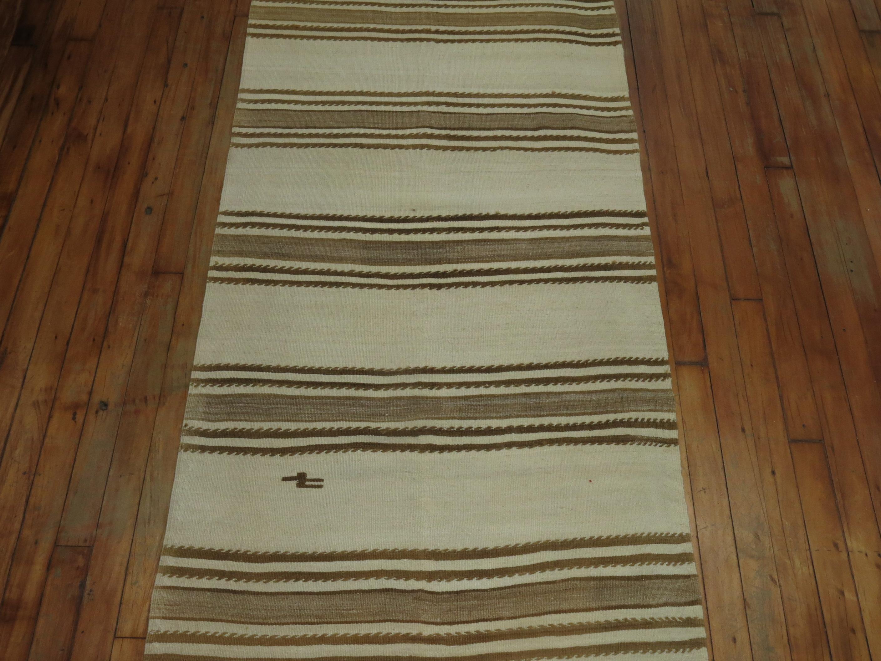 Rare narrow and long striped Kilim runner in white and brown.