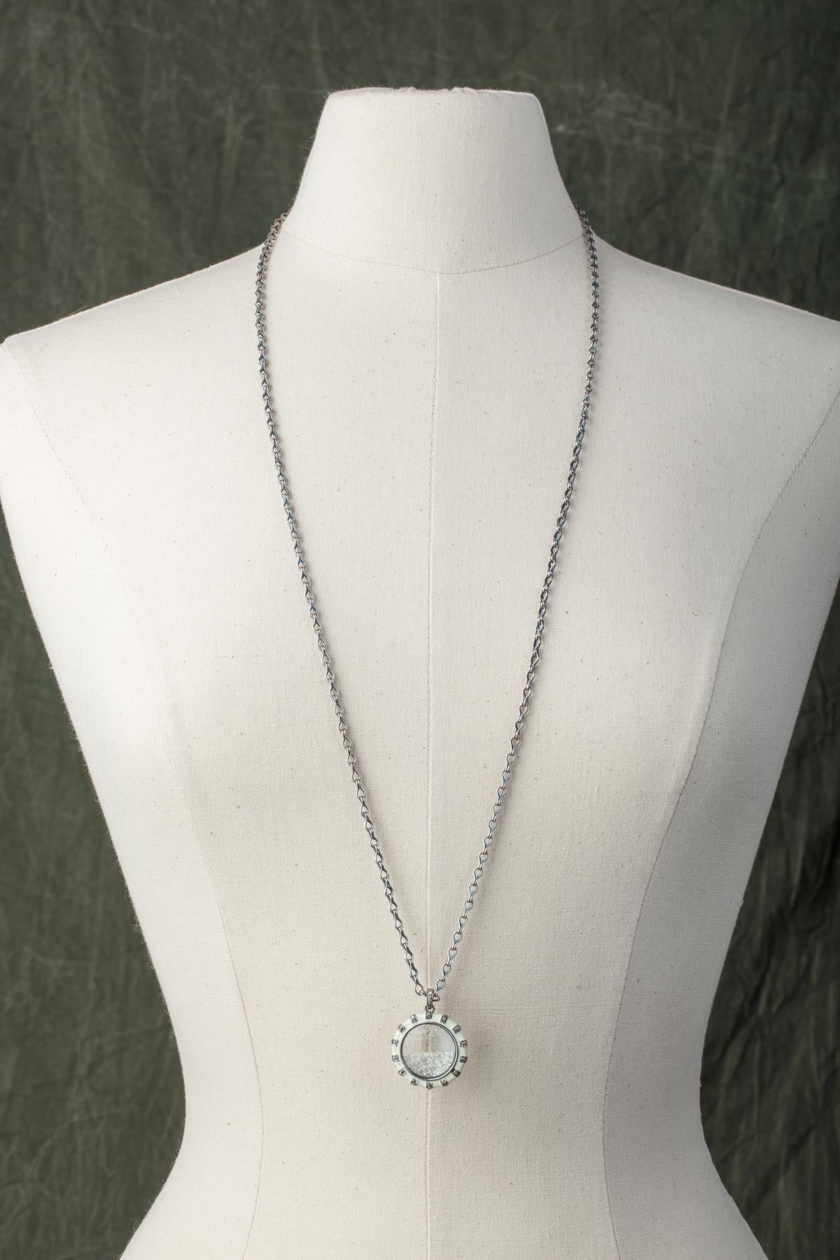 Two-sided, white enamel pendant with inset diamonds and faceted, loose diamonds in the picture frame beveled glass.  Hangs from a hand-made sterling silver chain.  Could be worn short or long. Carat weight of diamonds is 3.34.