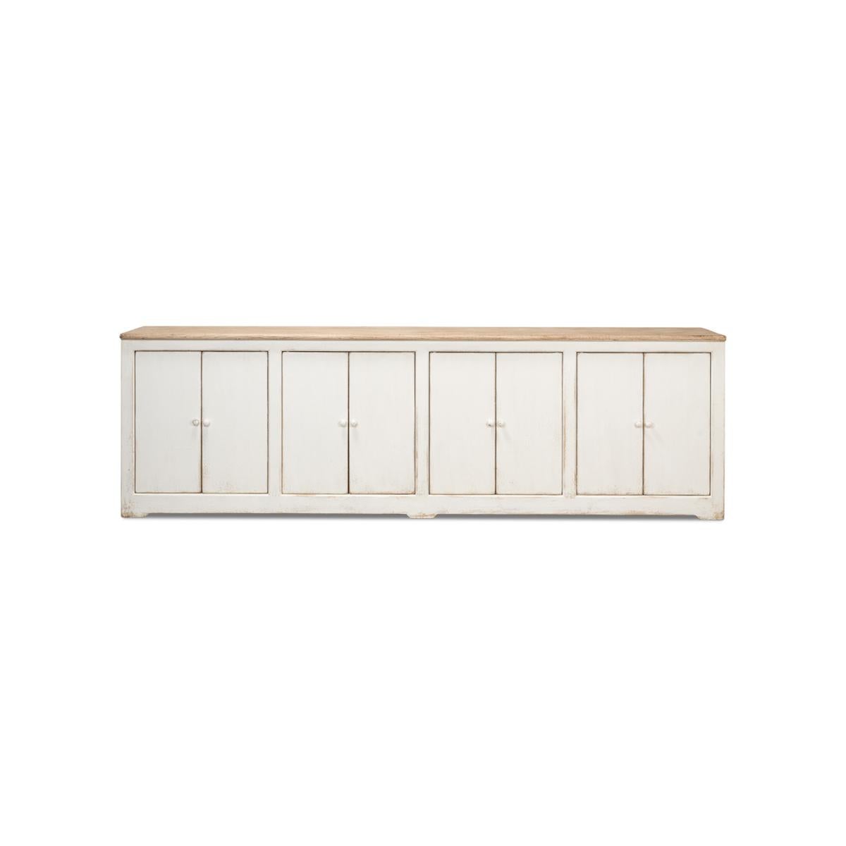 An eight door pine sideboard cabinet with a soft painted rub through antiqued whitewash finish with a natural finish top. Doors open to reveal a painted interior with removable shelves.

Dimensions: 122