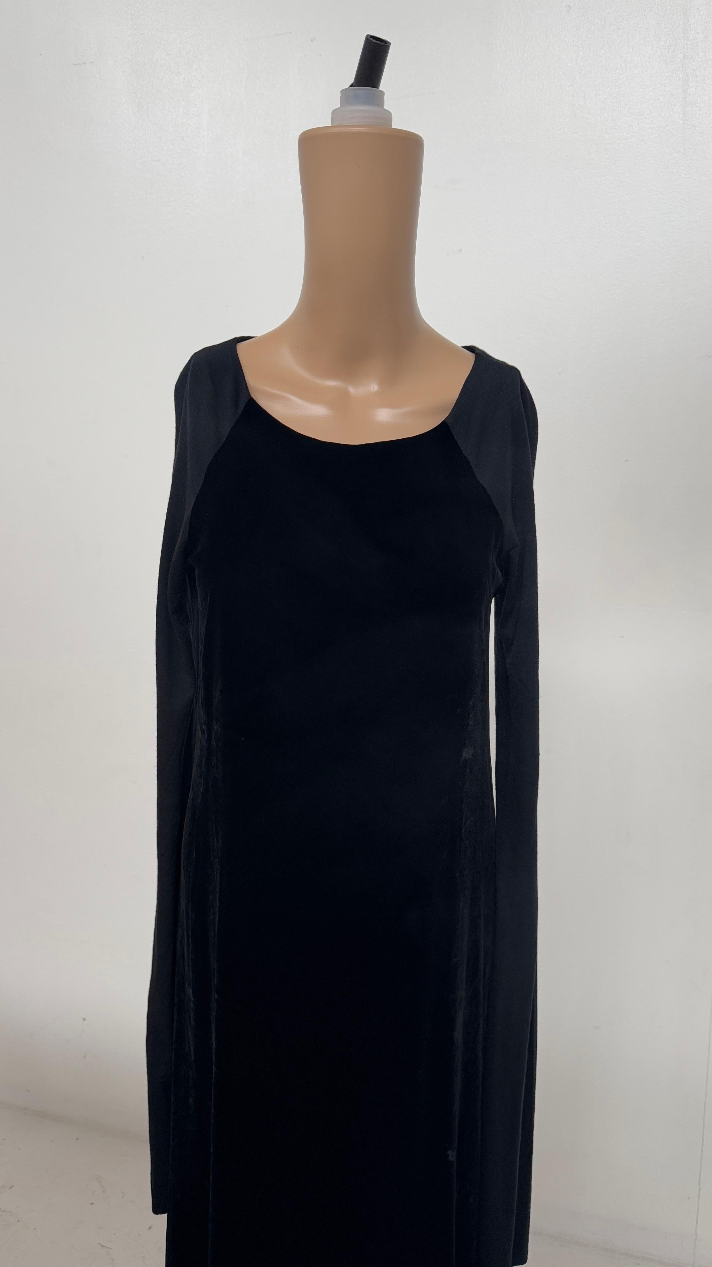 Entdecken Sie die schlichte Eleganz dieses langen schwarzen Kleides von Marina Sinibaldi Benatti, ein raffiniertes Stück, das minimalistische Linien mit taktilem Reichtum verbindet. Das in Italien gefertigte Kleid zeichnet sich durch eine schlanke