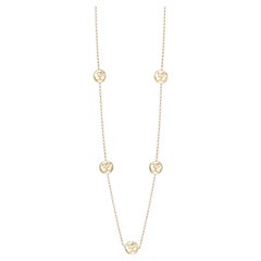 Long collier pendentif artisanal en or 14 carats avec le symbole OM